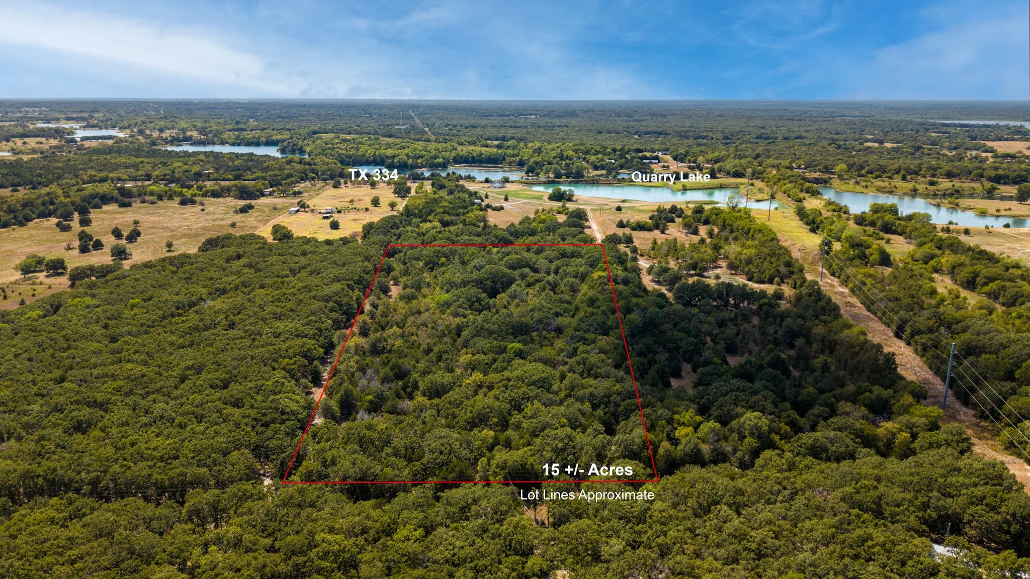 Expansive 15+/- acre wooded parcel featuring mature trees, a clear boundary outline, and proximity to a body of water
