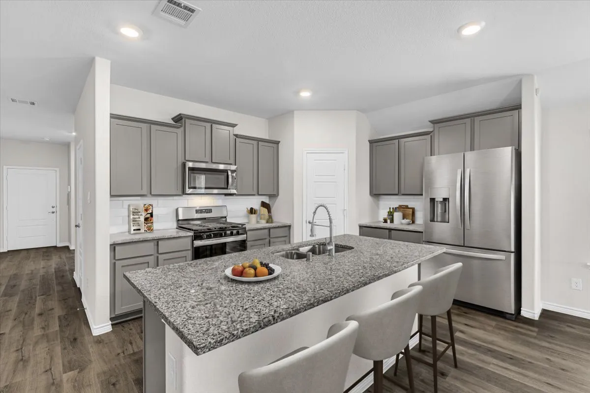 Open and spacious island kitchen, virtually staged to show the potential