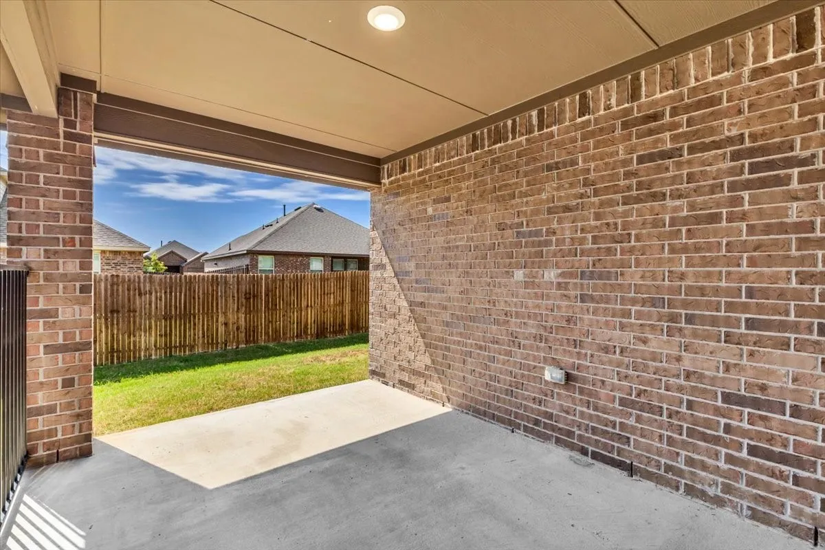 Large covered patio overlooks backyard