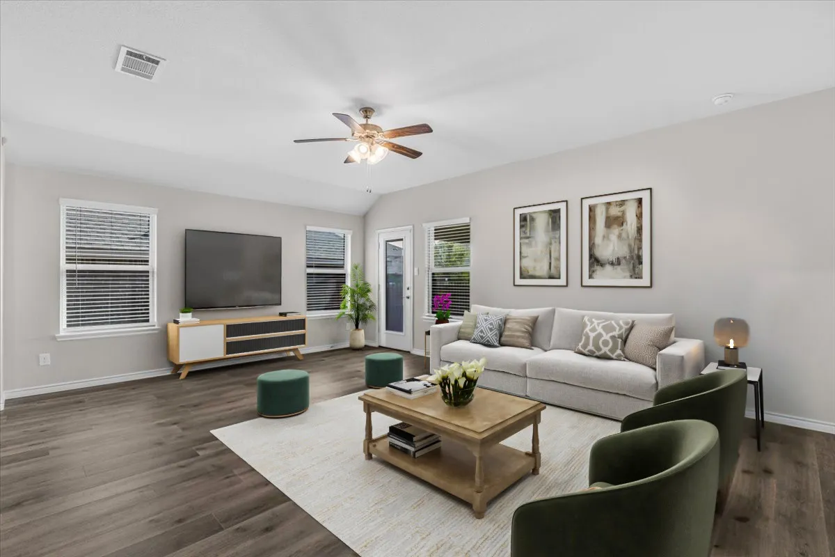 Huge family room with direct access to rear covered patio, virtually staged to show the potential