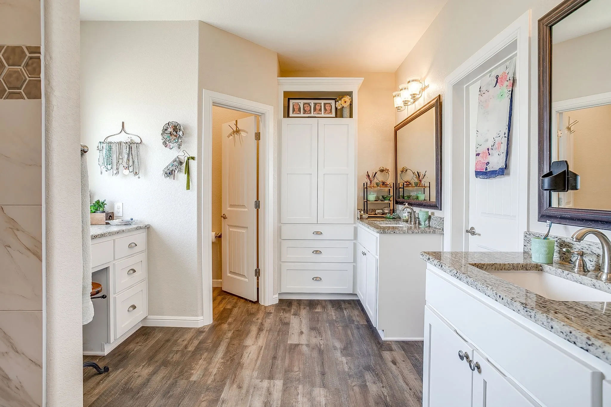 Dual vanity sinks with granite countertops and chrome fixtures