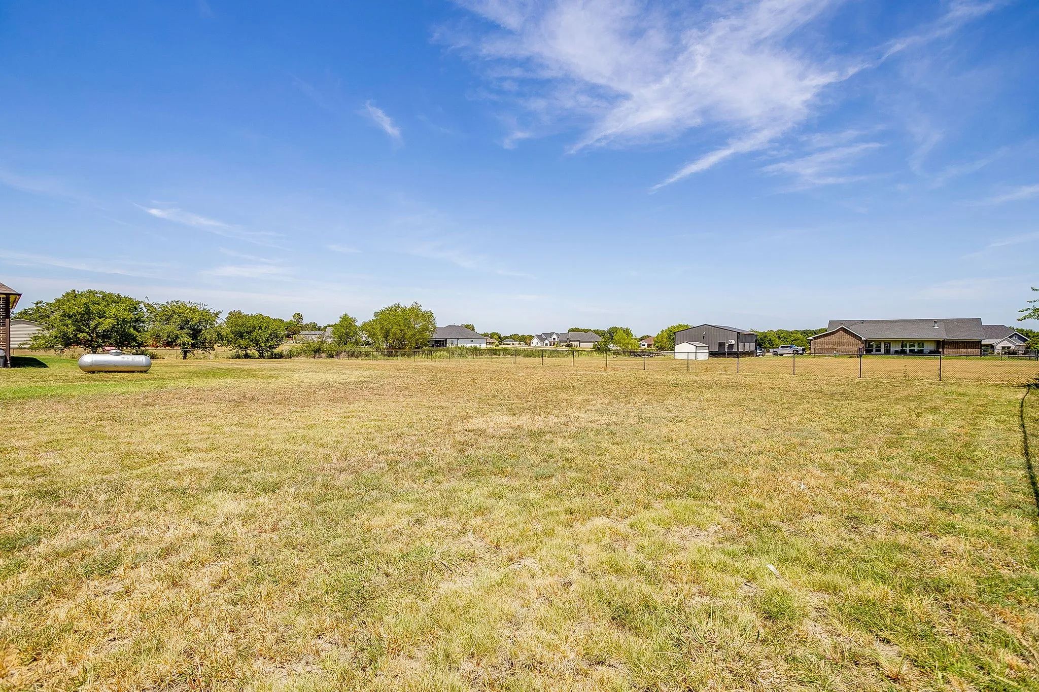 Expansive level lot offering abundant open space with mature trees and established landscaping