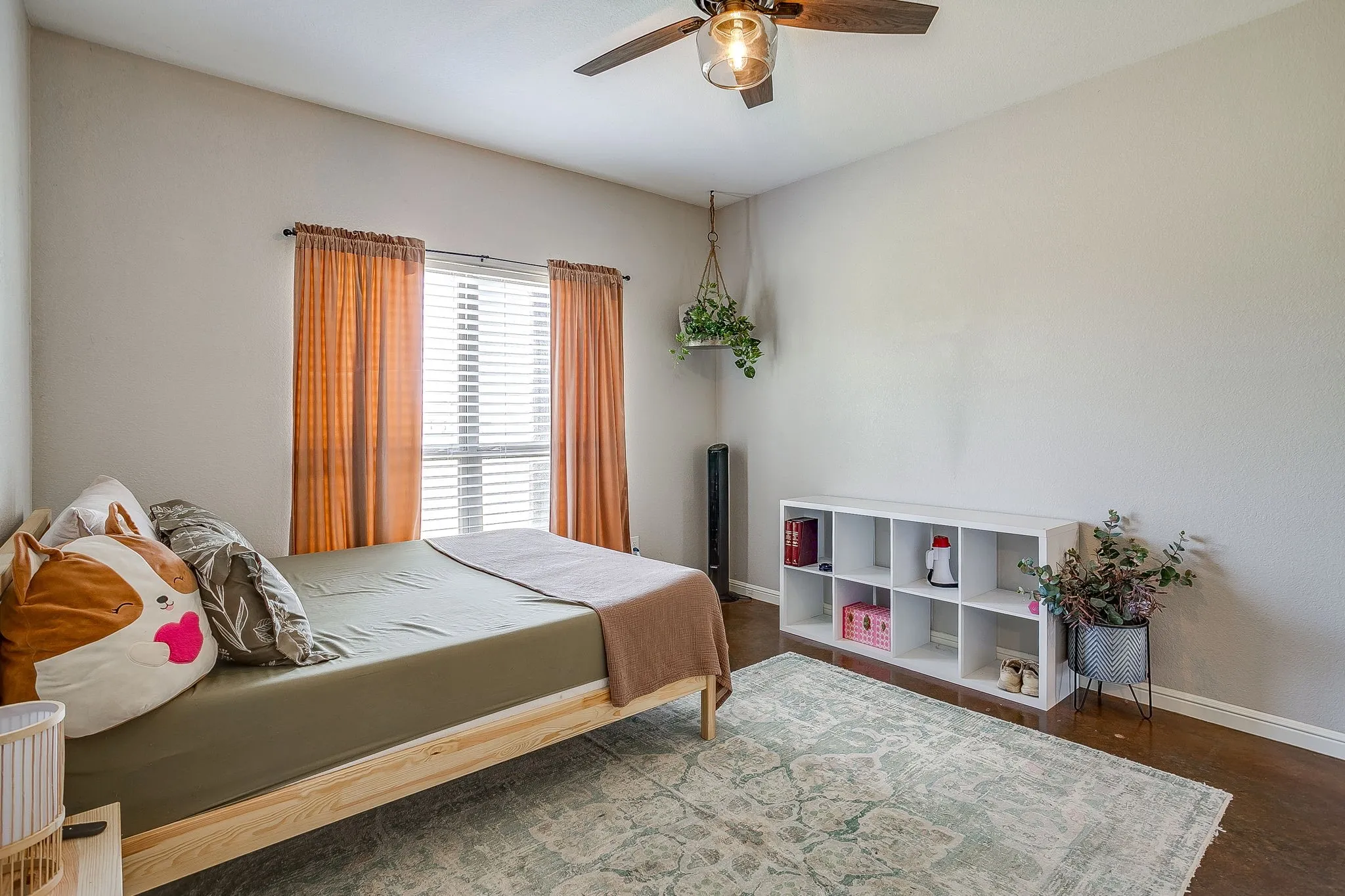 Hardwood-finish flooring with a ceiling fan light fixture