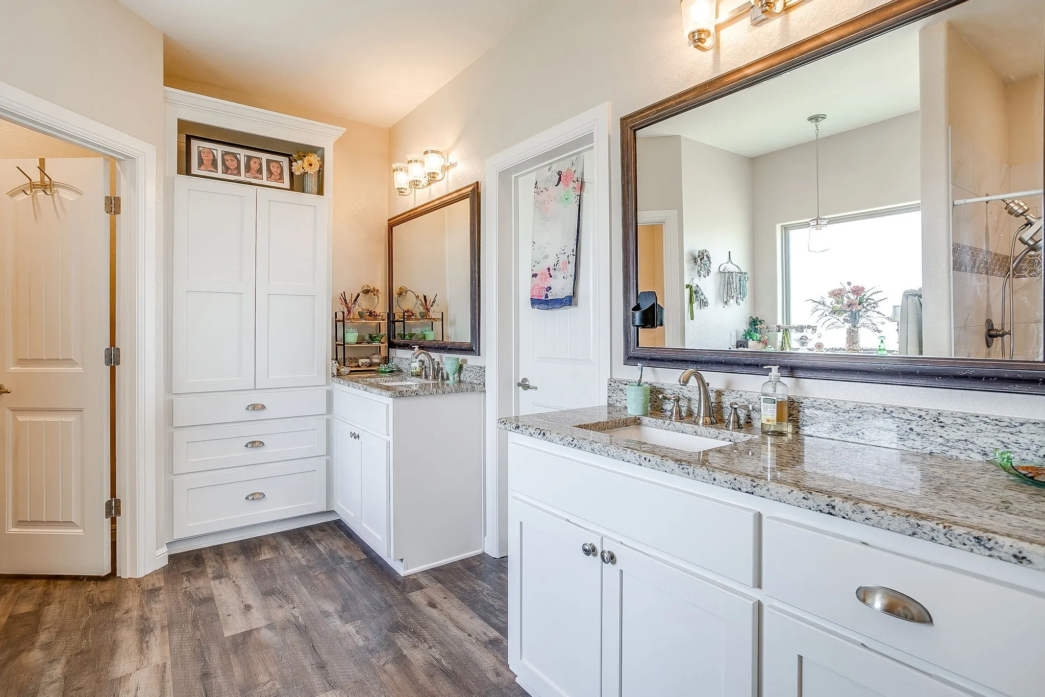 Dual vanity with undermount sinks, granite countertops, and brushed nickel fixtures