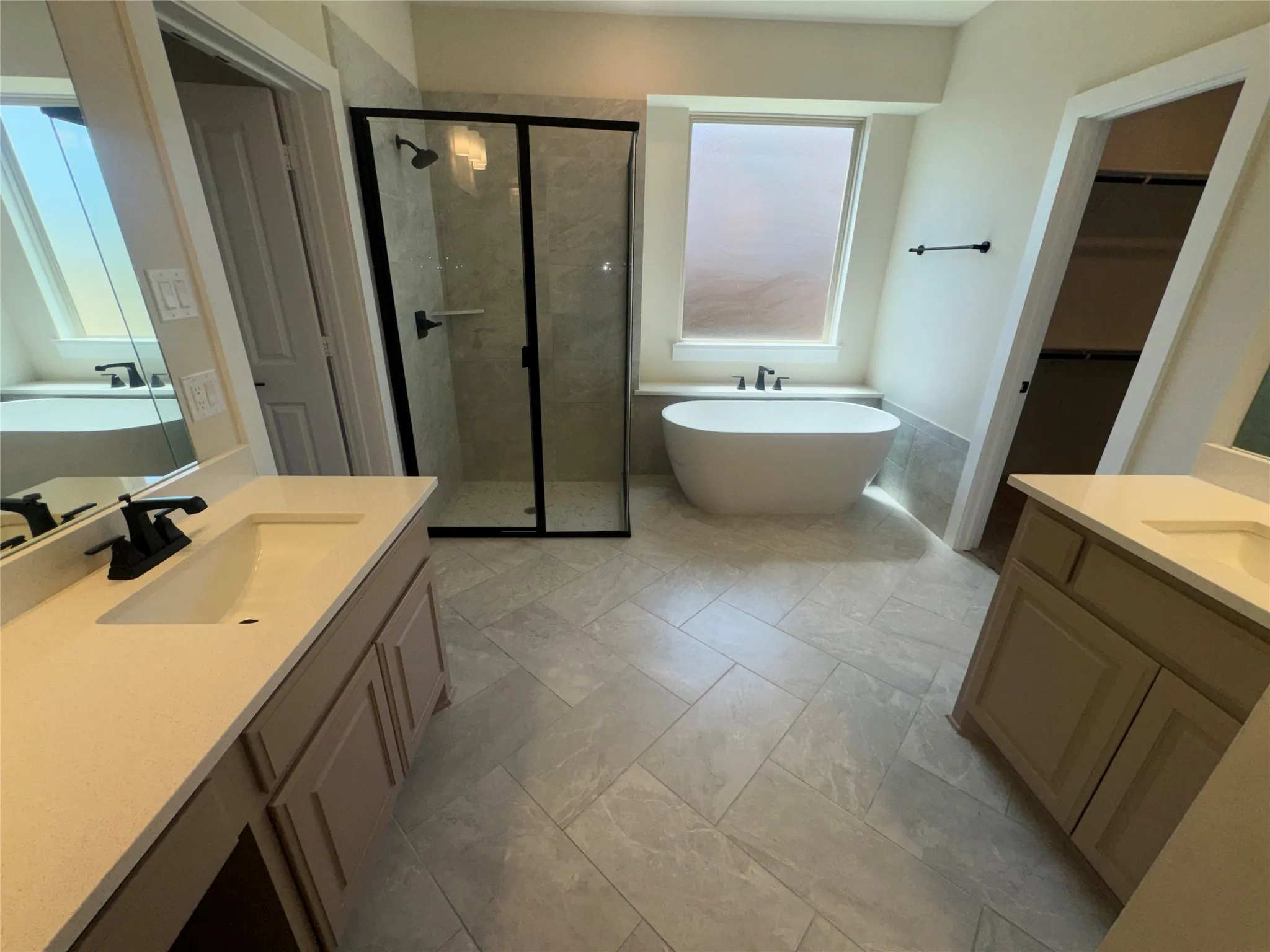 Dual vanities with integrated sinks and matte black fixtures