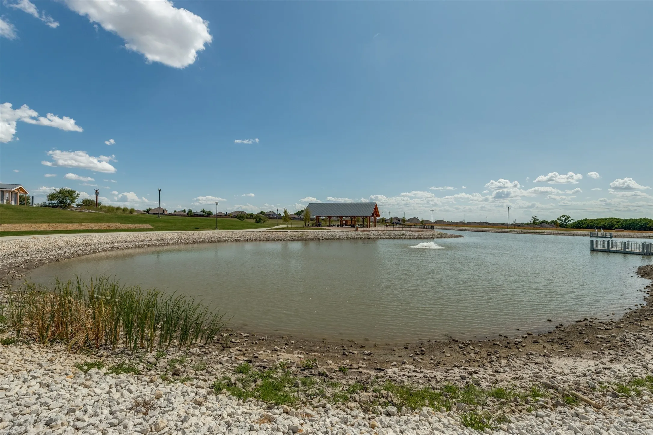 Community pond with dock and covered pavilion