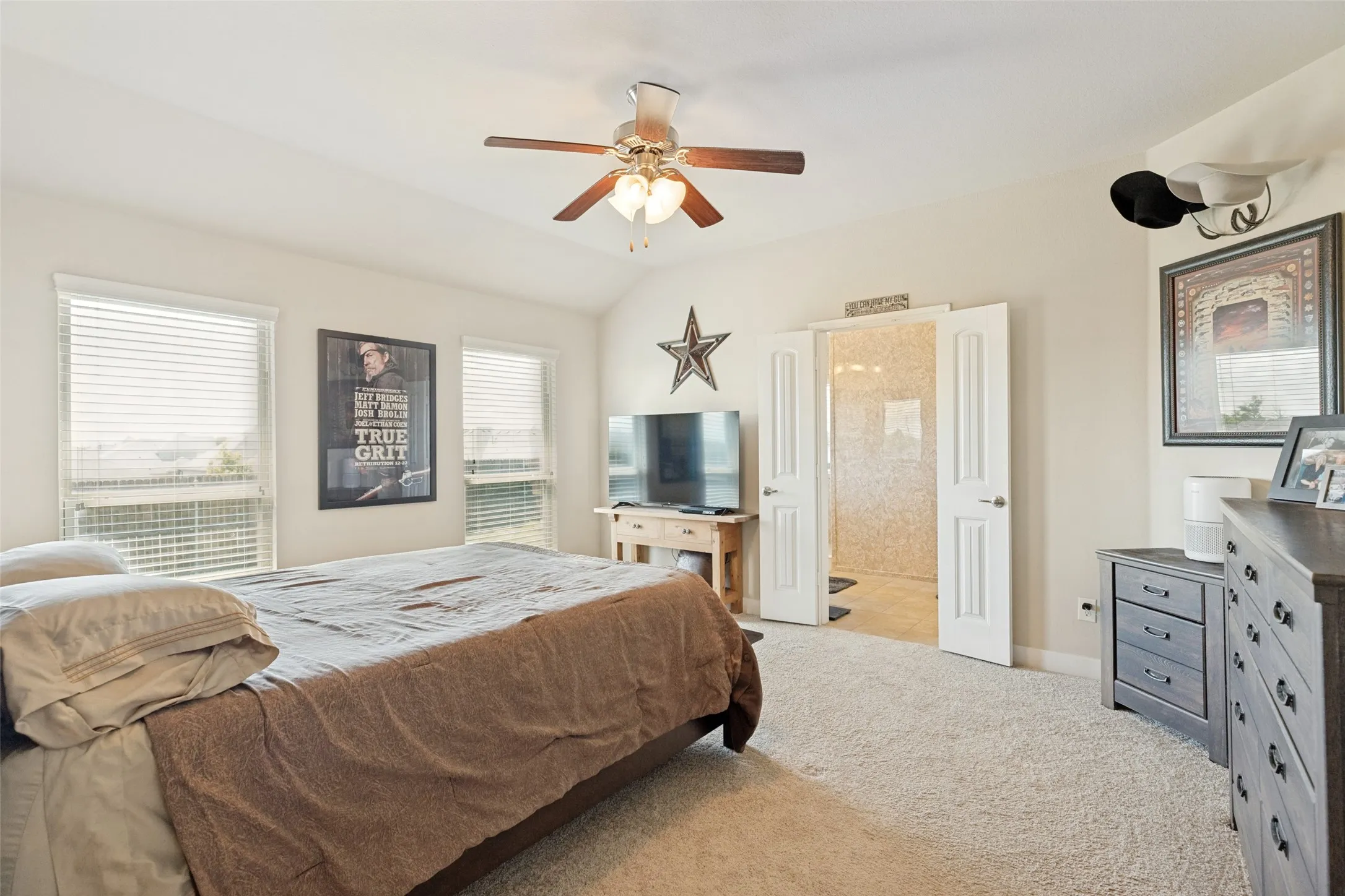 Vaulted ceiling with a ceiling fan, carpeted flooring with blinds