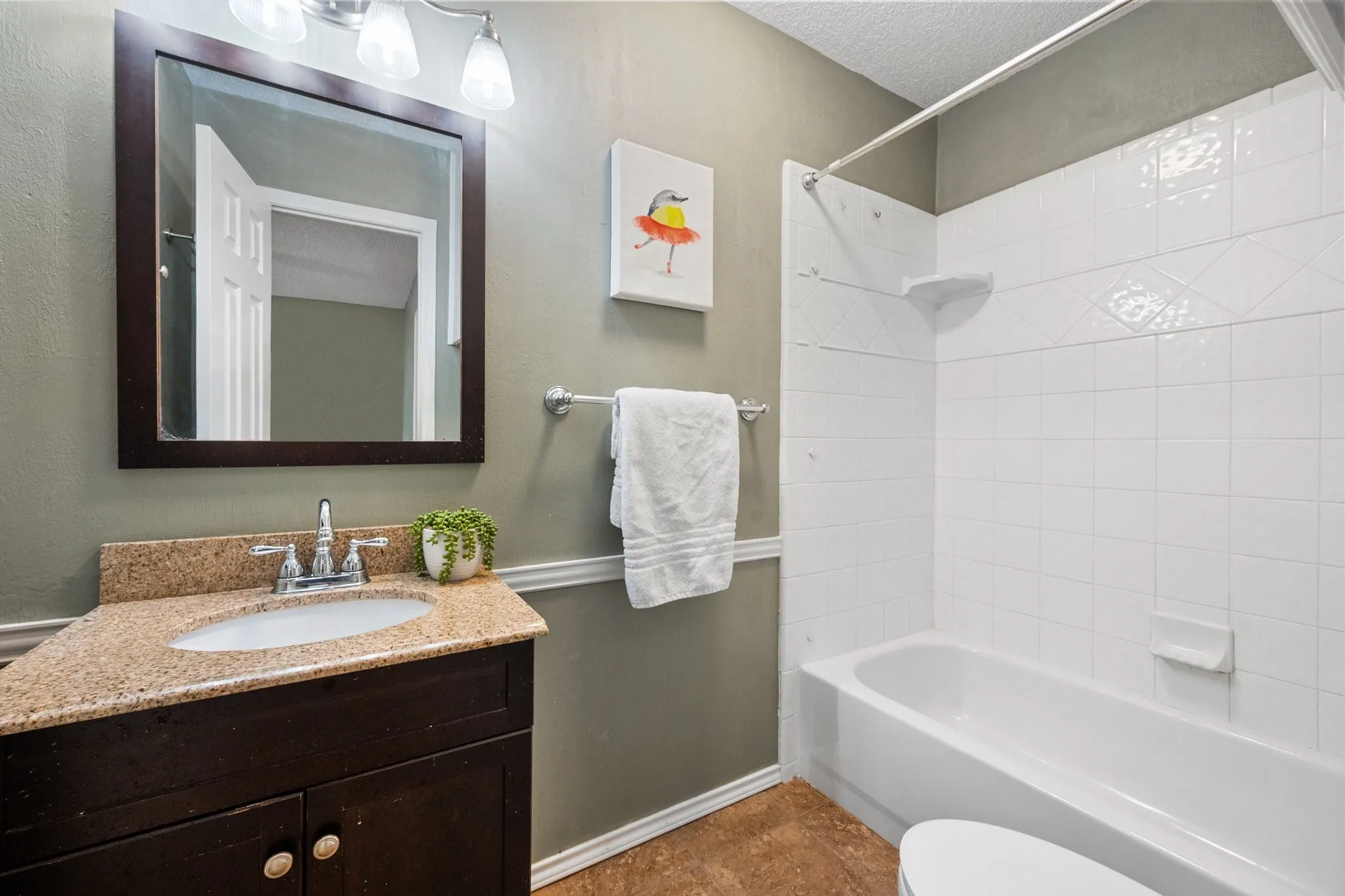 Primary bathroom offers generous counter space, ample cabinetry, and a separate walk-in shower.