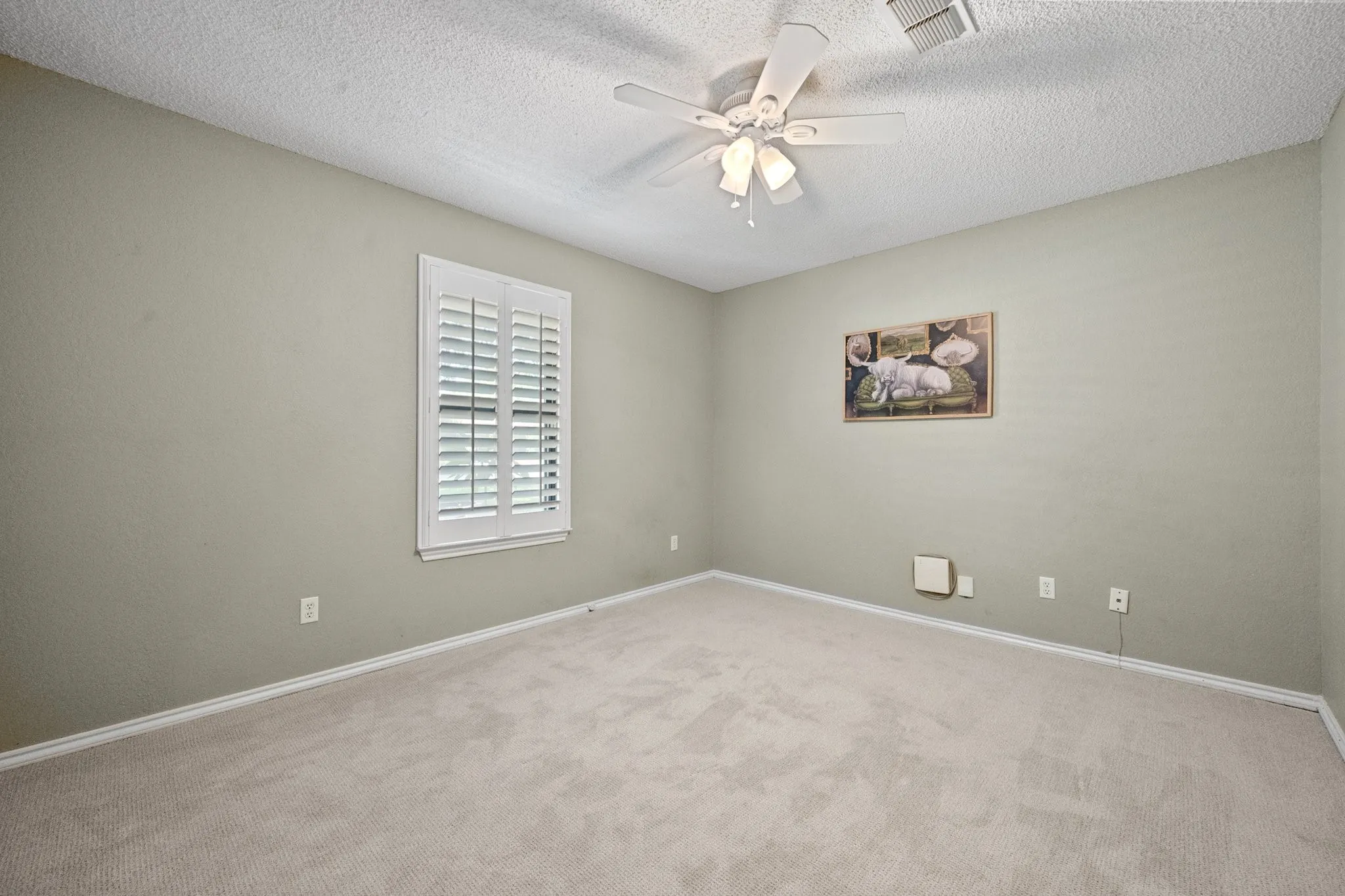One of three secondary bedrooms, ready to serve as a bedroom, home office, hobby room, or whatever best fits your needs.