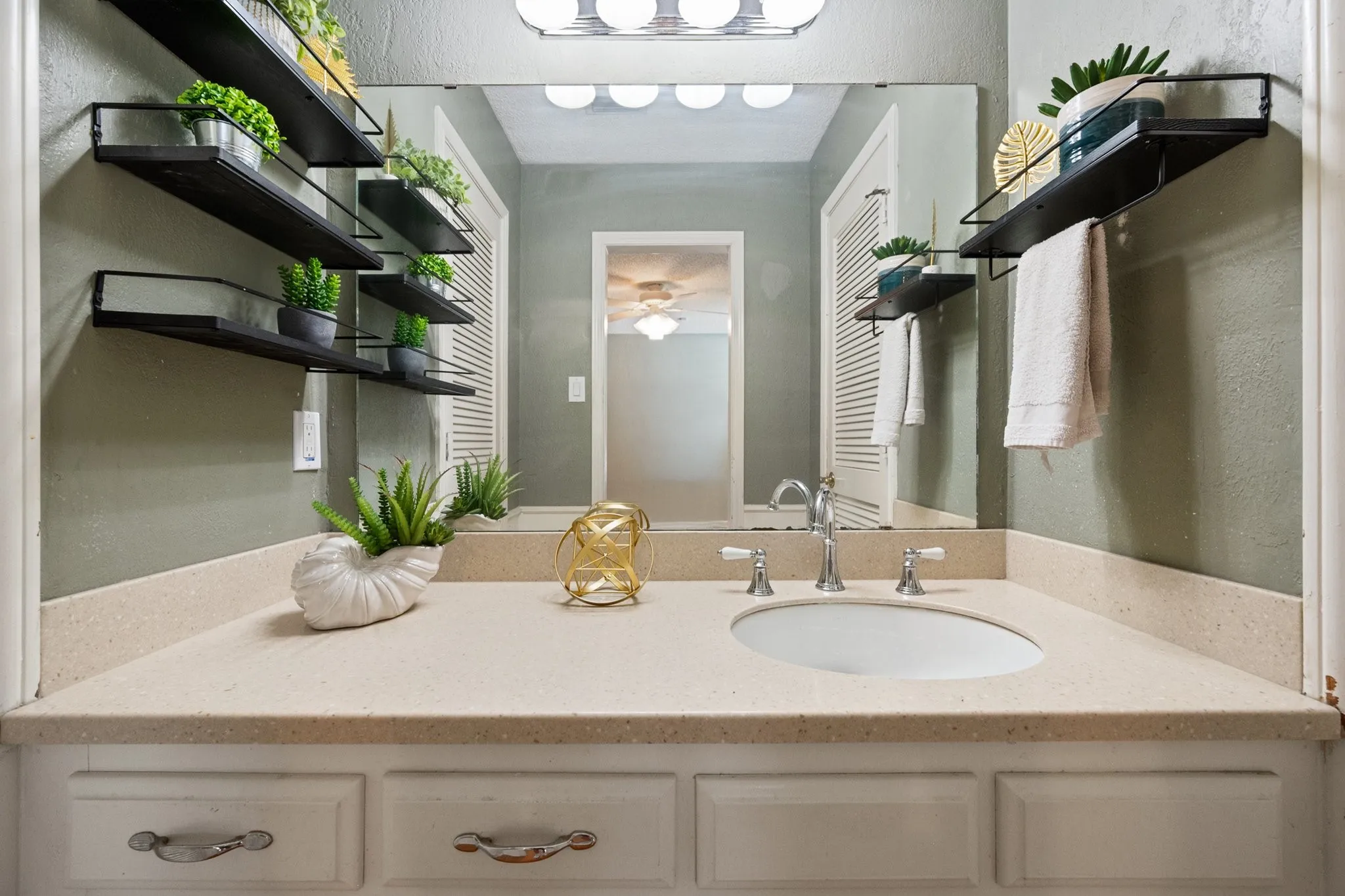 The primary bath provides an extended vanity and generous counter space, with the separate shower located just beyond.