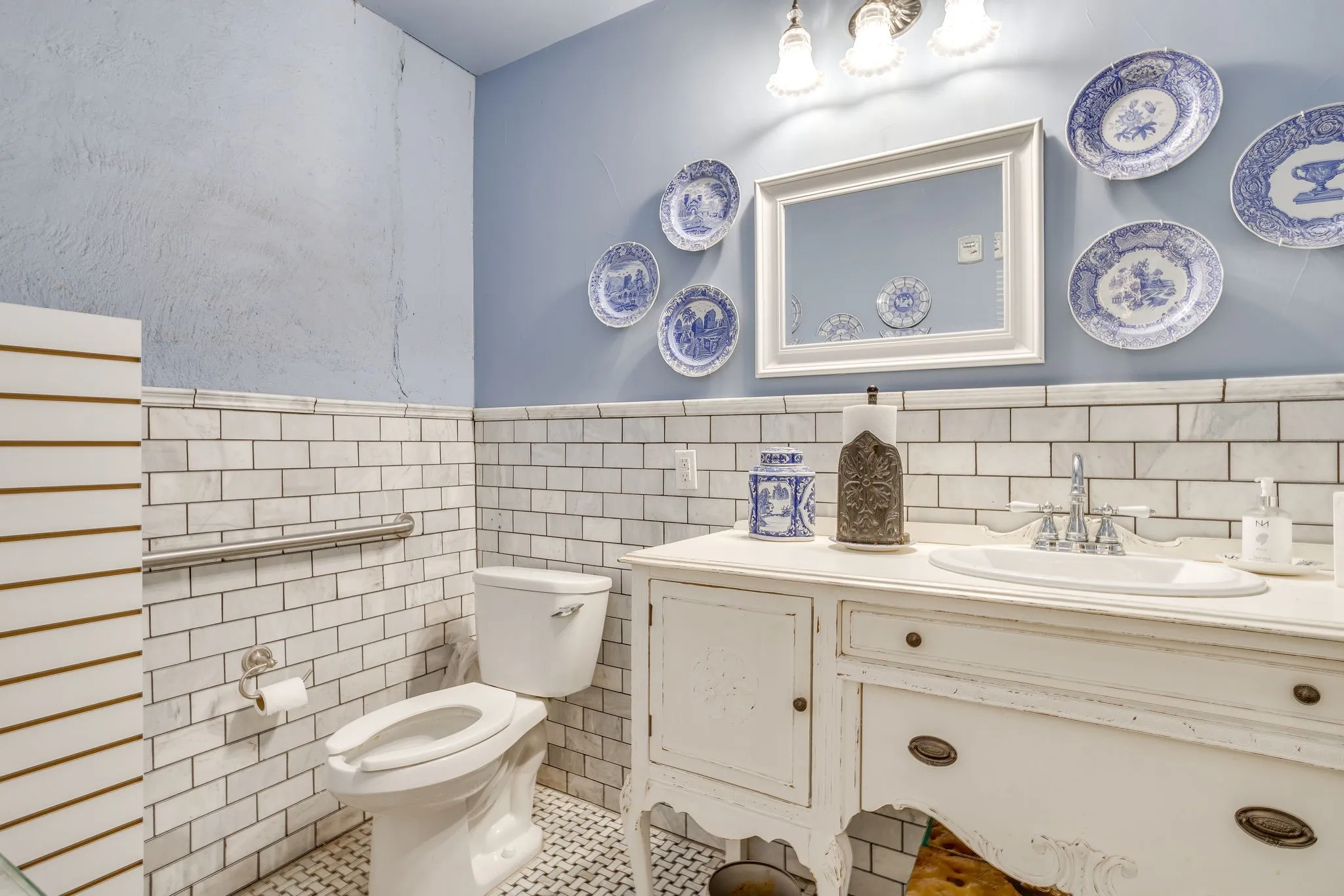 A roomy bathroom located near the elevator at the back of the space.