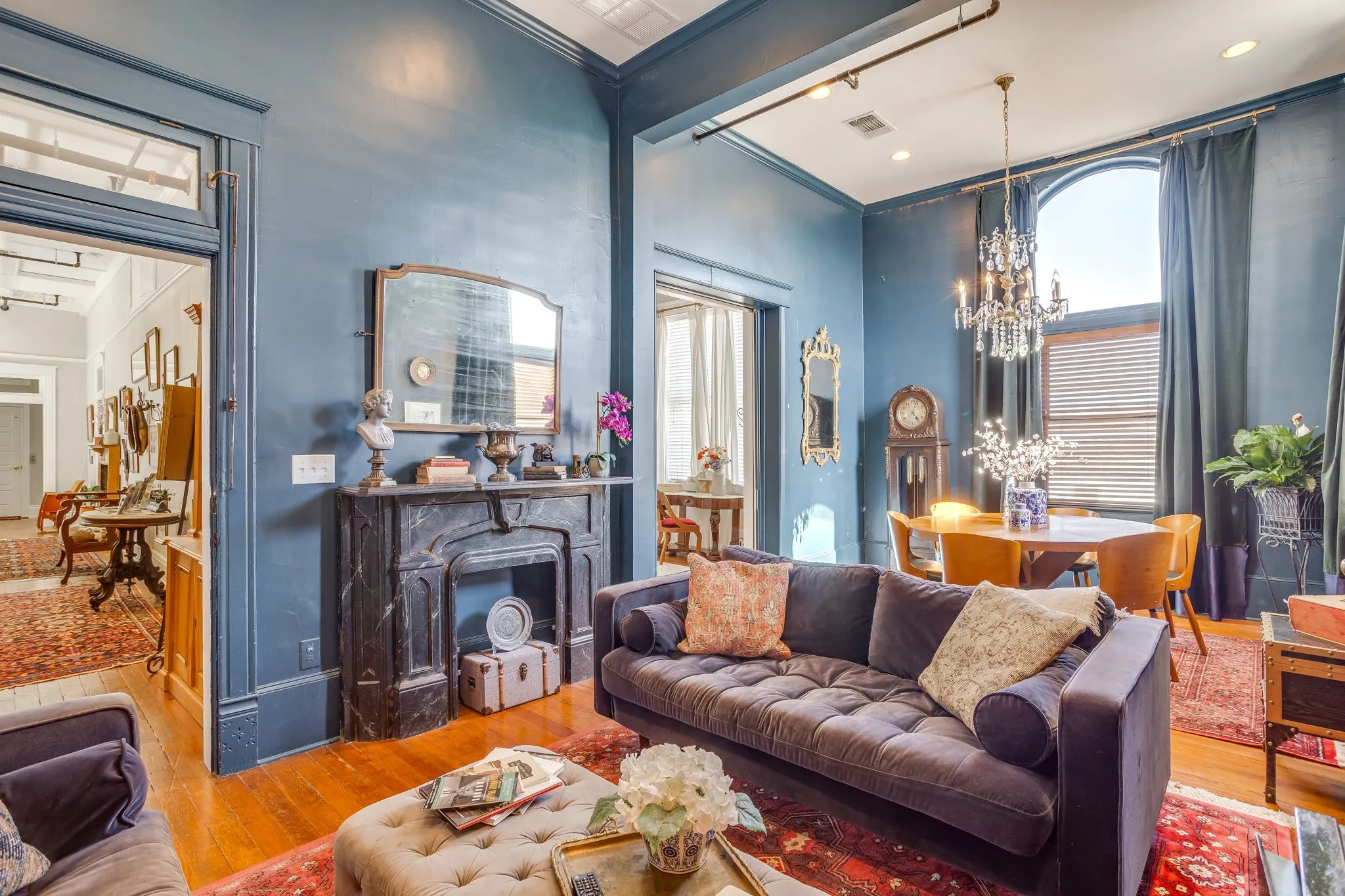 A gorgeous antique, marble fireplace mantle creates the perfect vignette for this space.