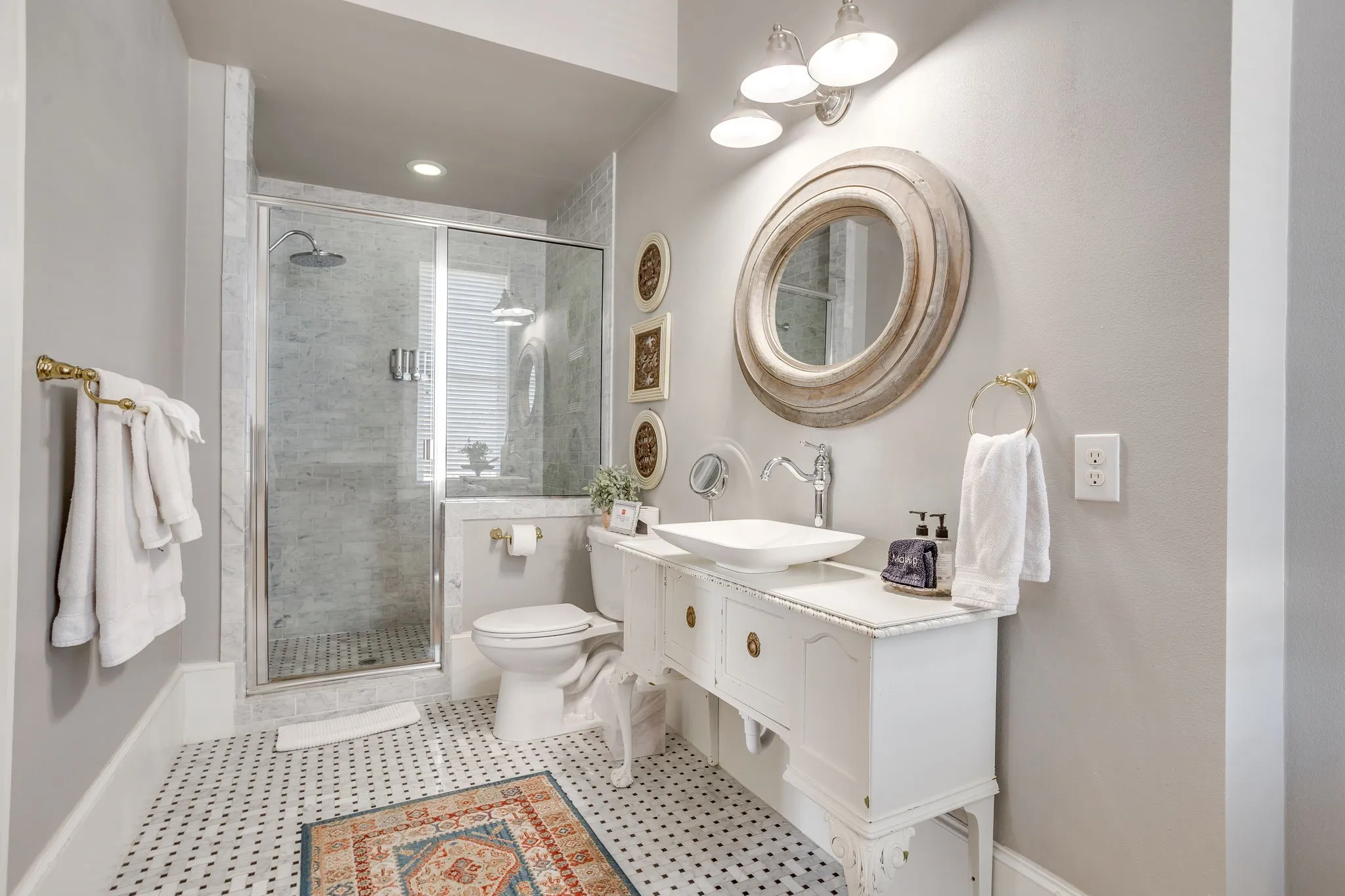 One of the two, full baths with detailed tile work, with antique pieces that keep this space feeling historic.