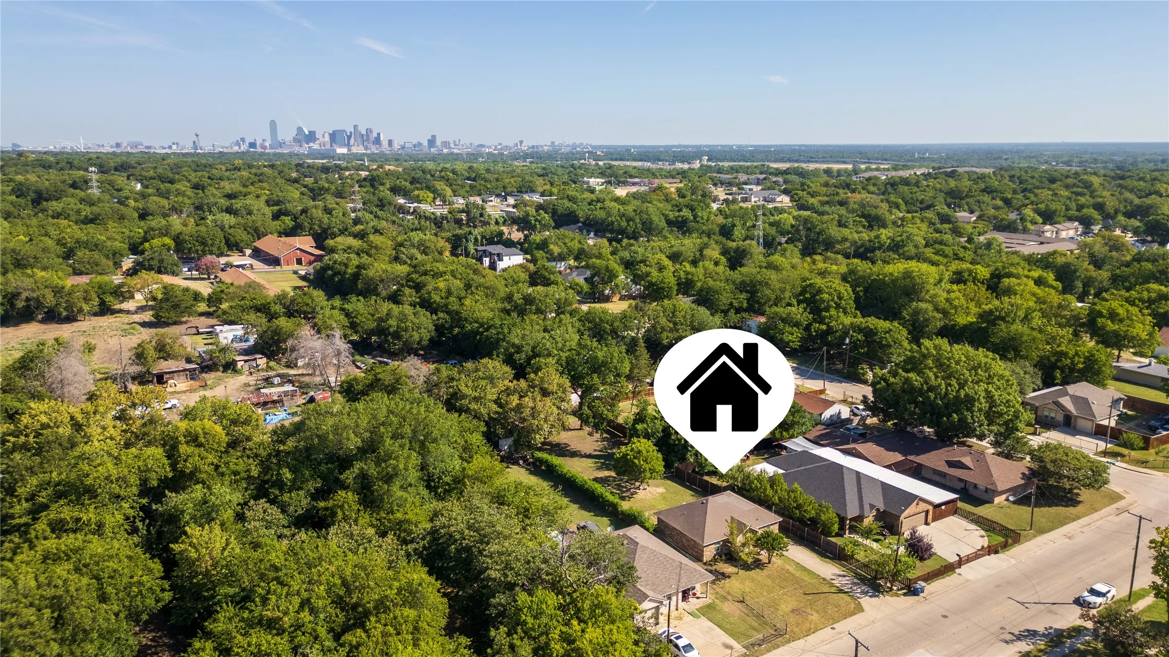 Aerial perspective showcasing a verdant neighborhood with a distant cityscape