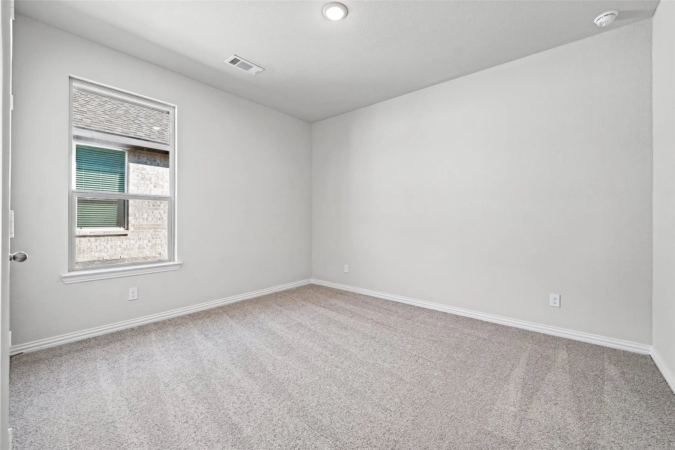 Neutral wall tones complemented by light-toned carpeting