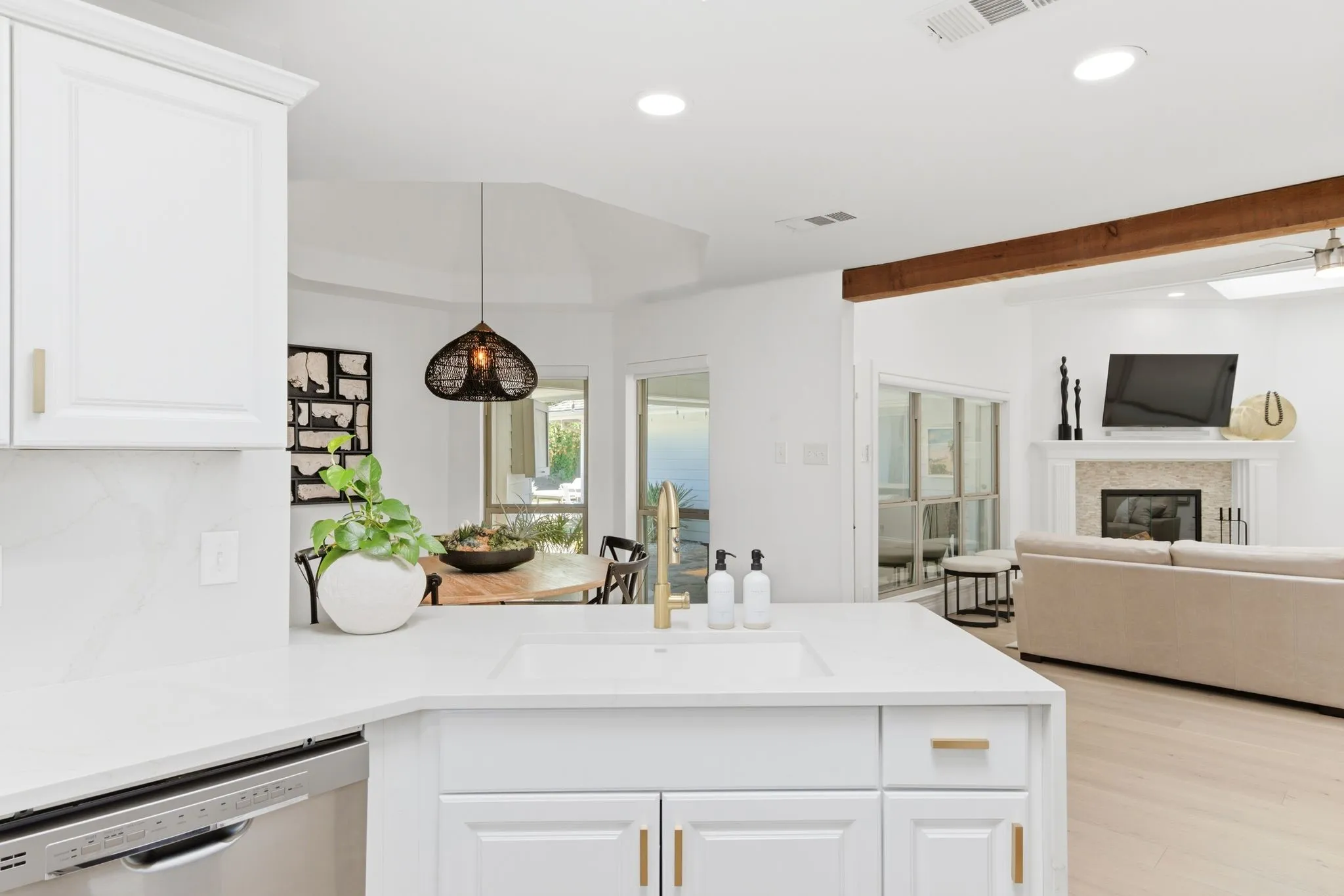 Kitchen vantage point of dine in breakfast area and living room