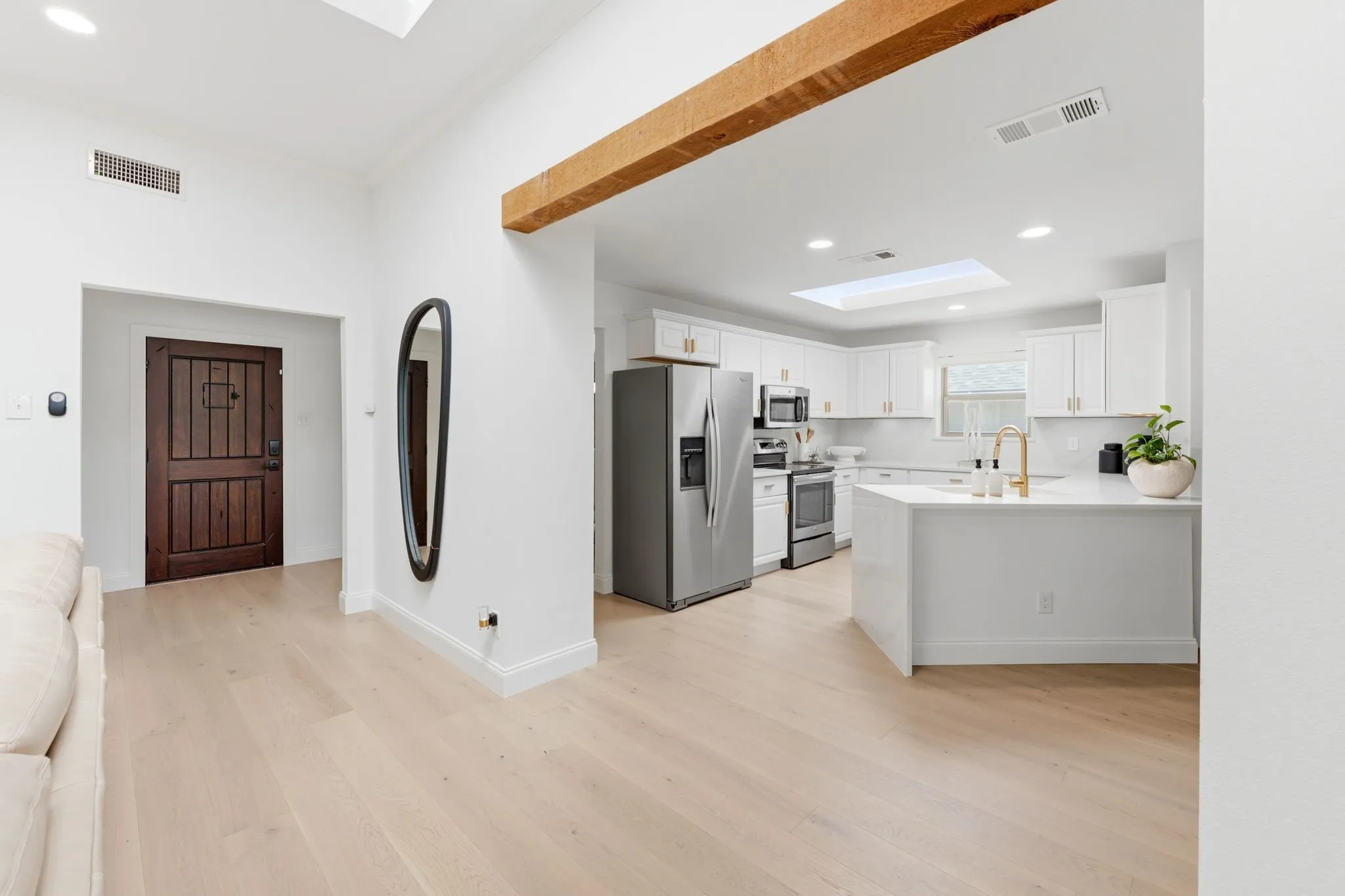 Vantage point in the living room of the entry way and kitchen