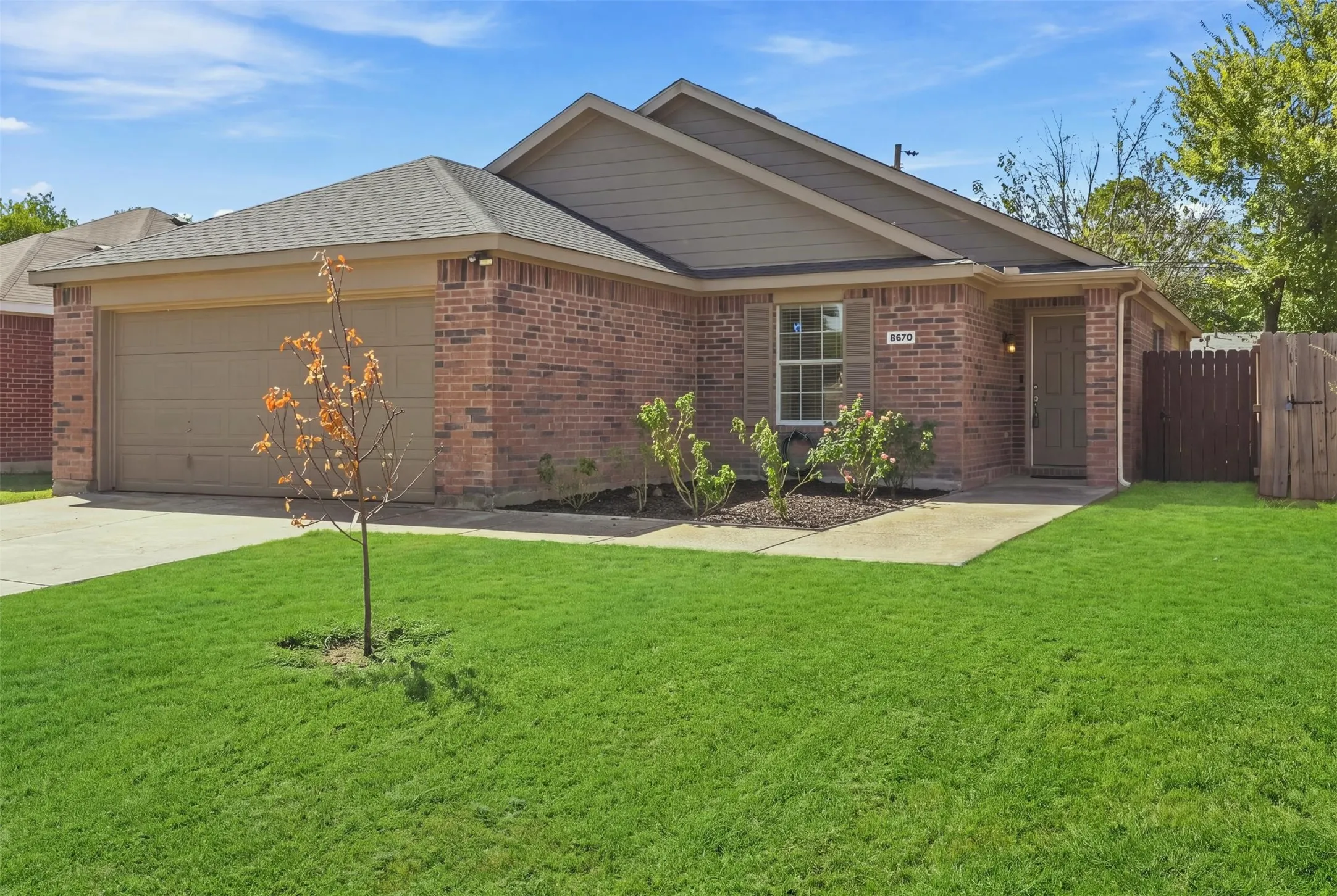 Brick exterior with a single-car garage and a concrete driveway