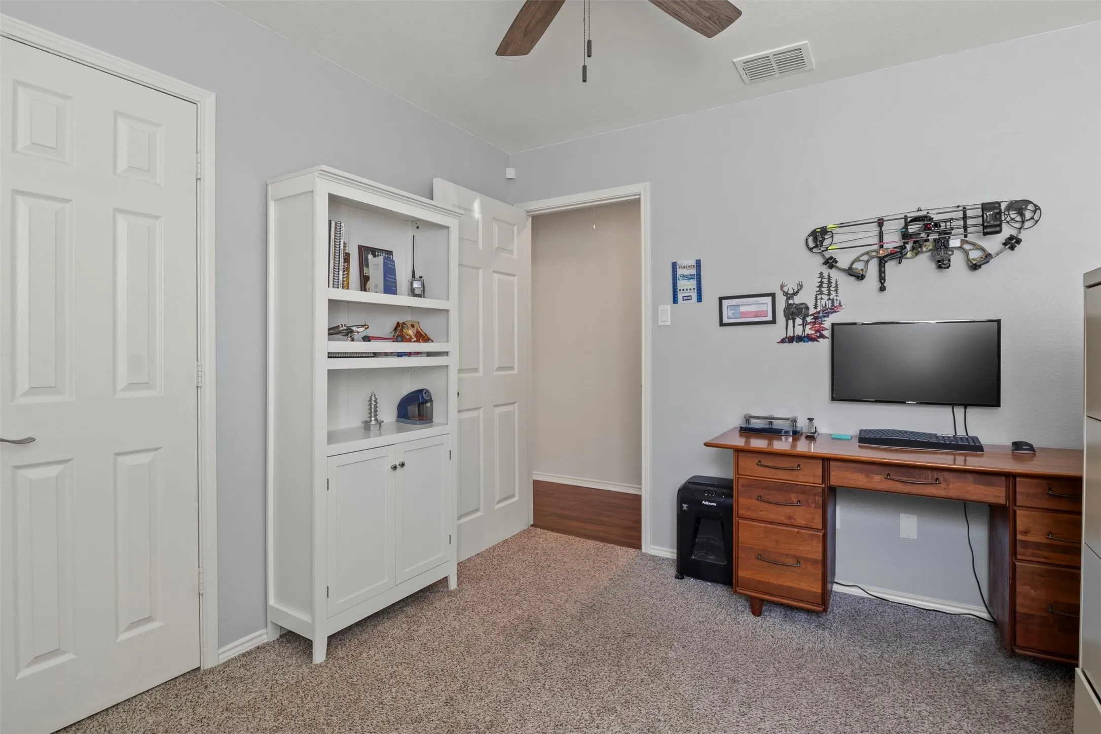 Neutral wall color, ceiling fan, and carpeted flooring