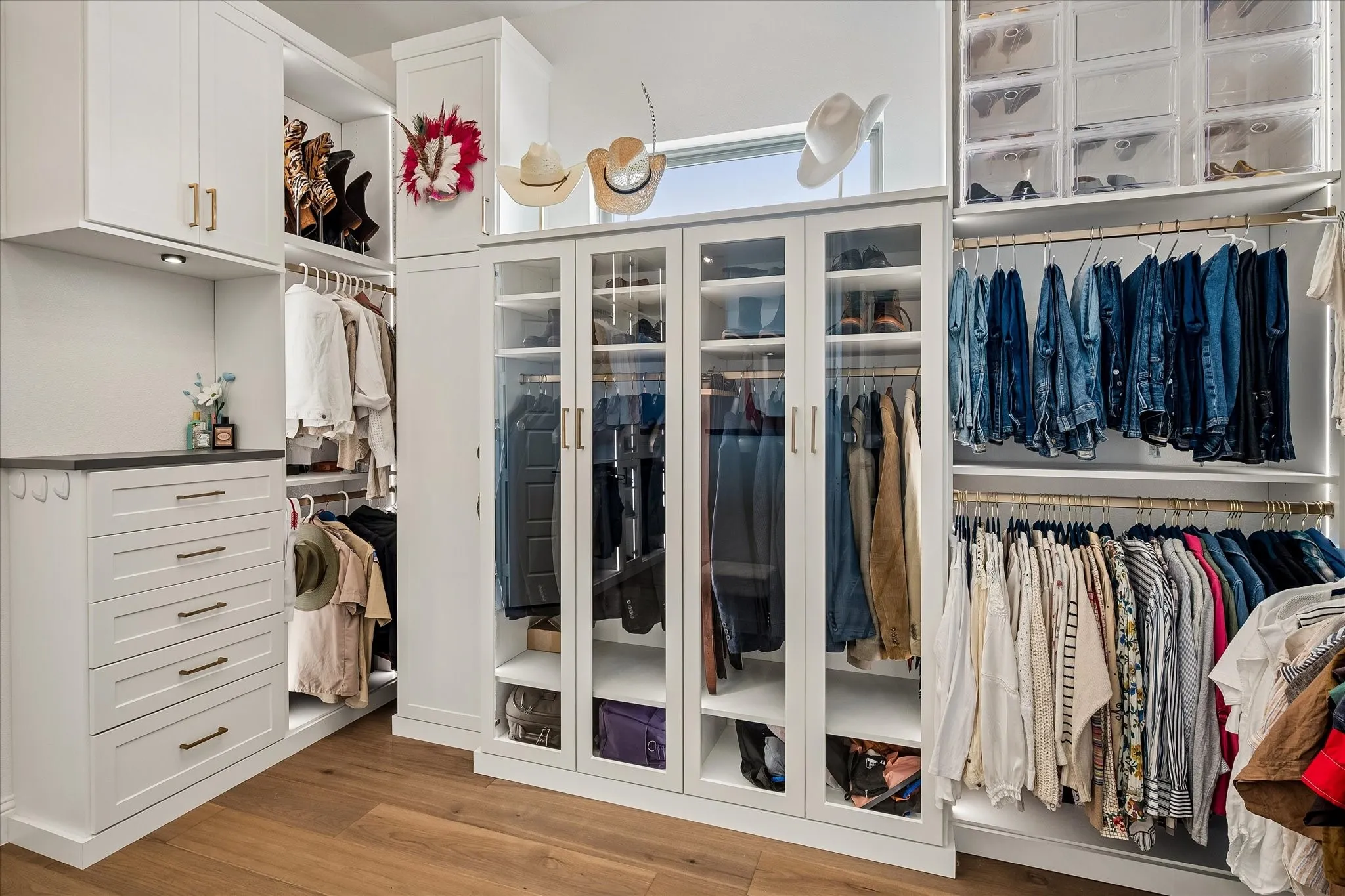 Check out this fabulous primary closet with custom lighting all designed by Inspired Closets.