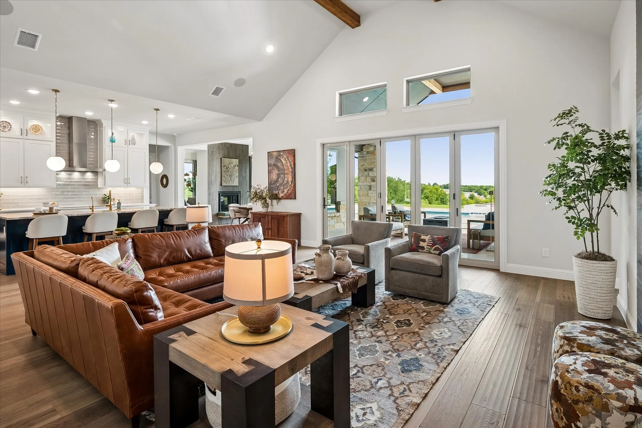 Loads of natural light, gorgeous view of the pool deck and surrounding vistas, vaulted ceiling with wooden beams, open floor plan.
