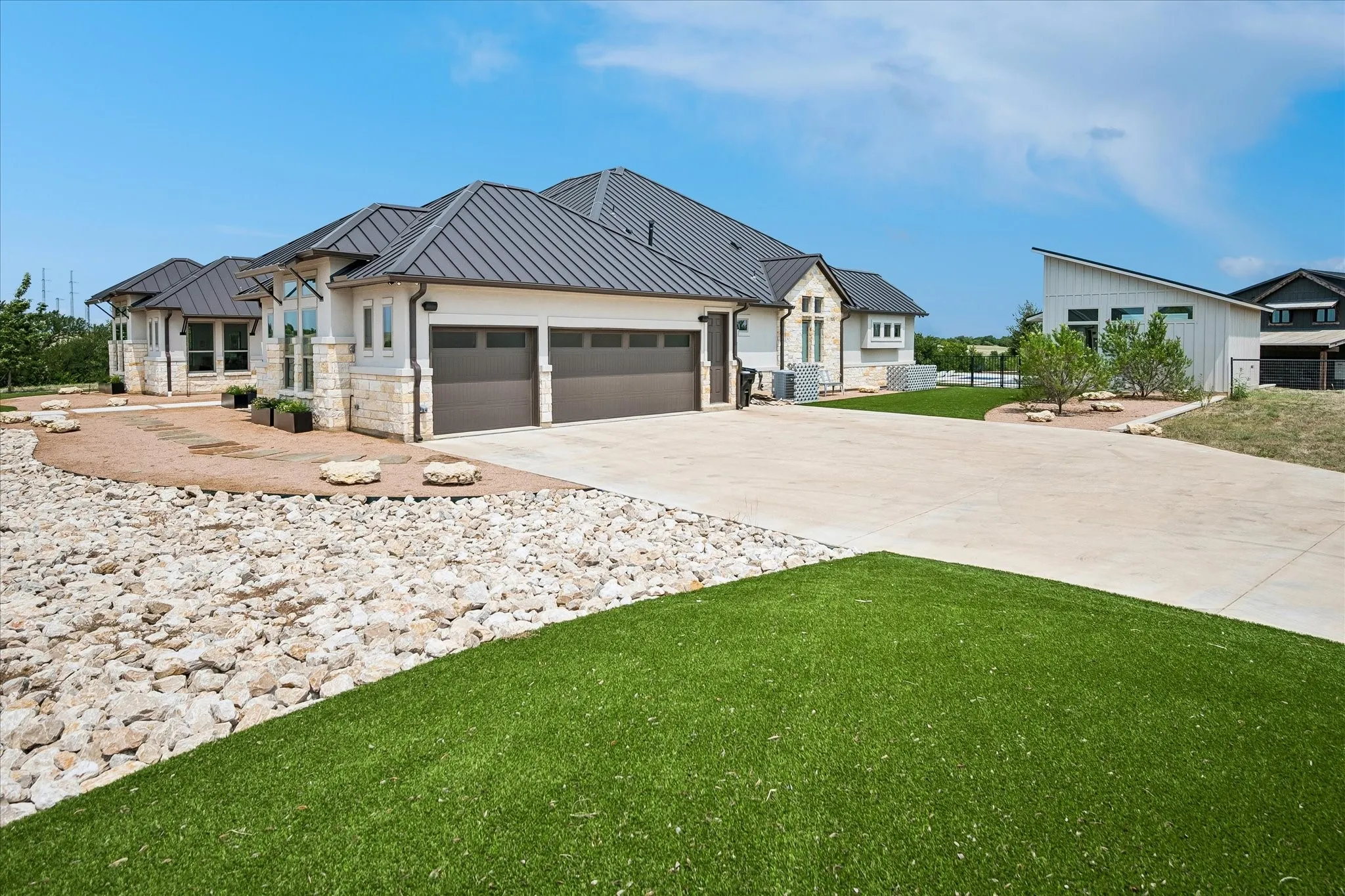 3 car extended garage with 220 volt car charger. Side entry door leading into the garage. Concrete driveway and gated solar-powered driveway gate with keypad entry.