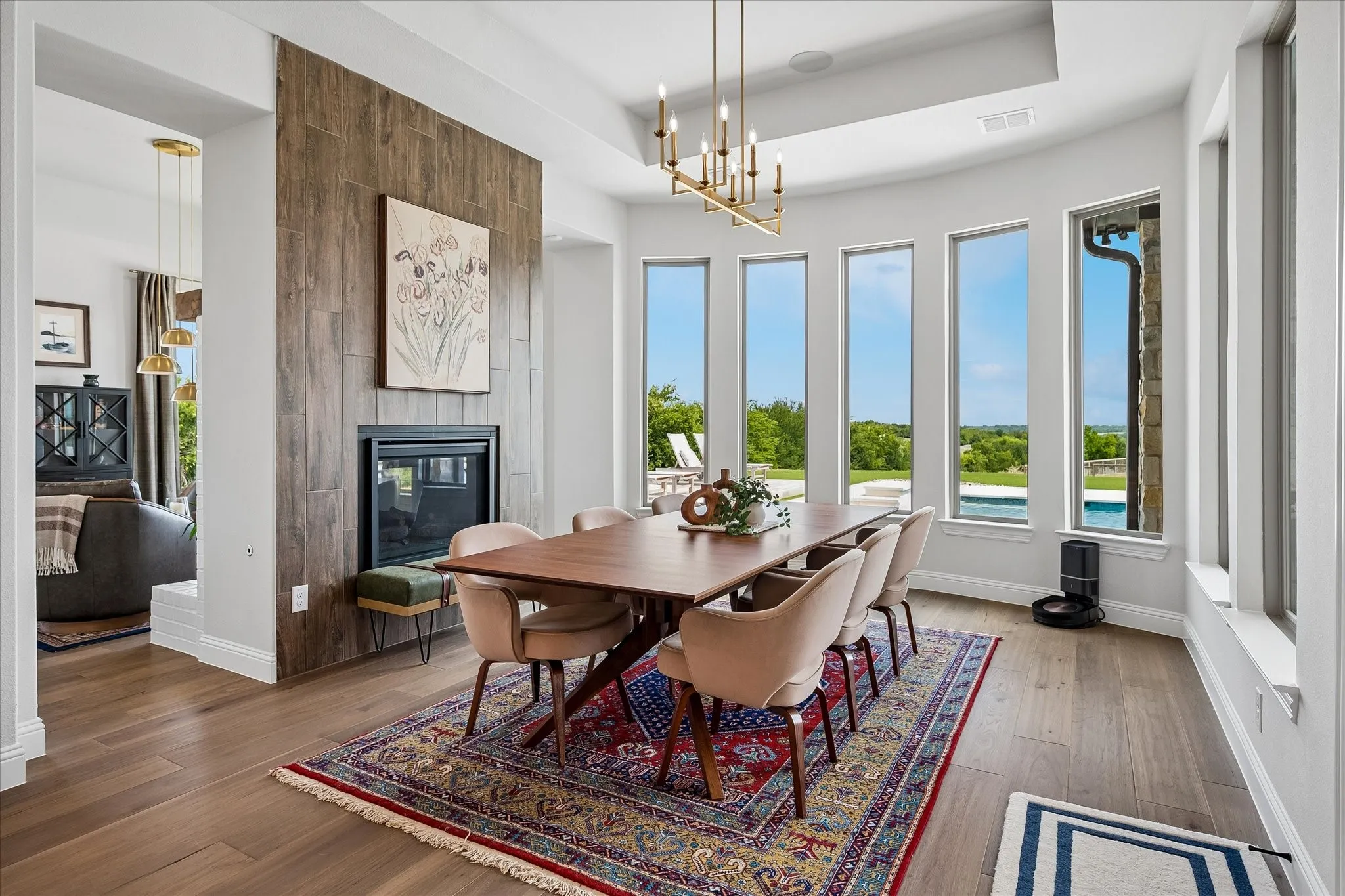 Dining room features double sided gas fireplace, spacious seating area with room for a very large table, and bay window