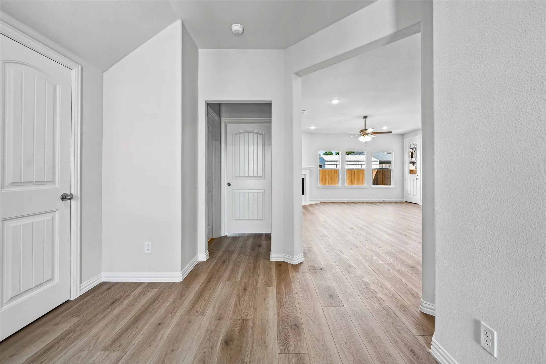 Open concept living area featuring wood-finish flooring, recessed lighting, and a ceiling fan