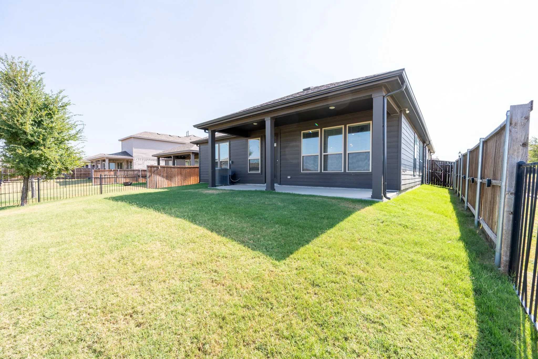 Large backyard corner lot with view of green space and walking trails