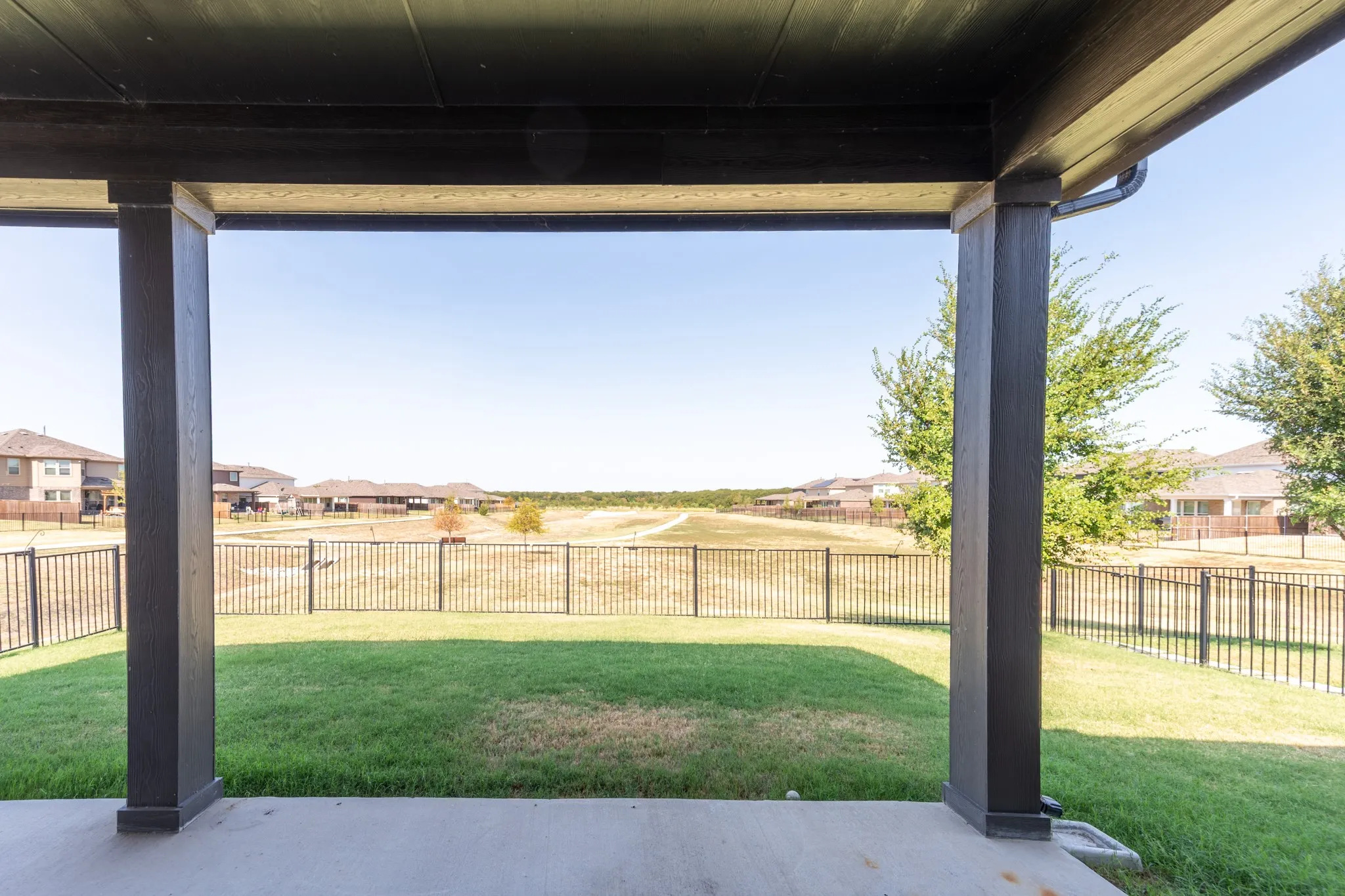 Large backyard corner lot with view of green space and walking trails