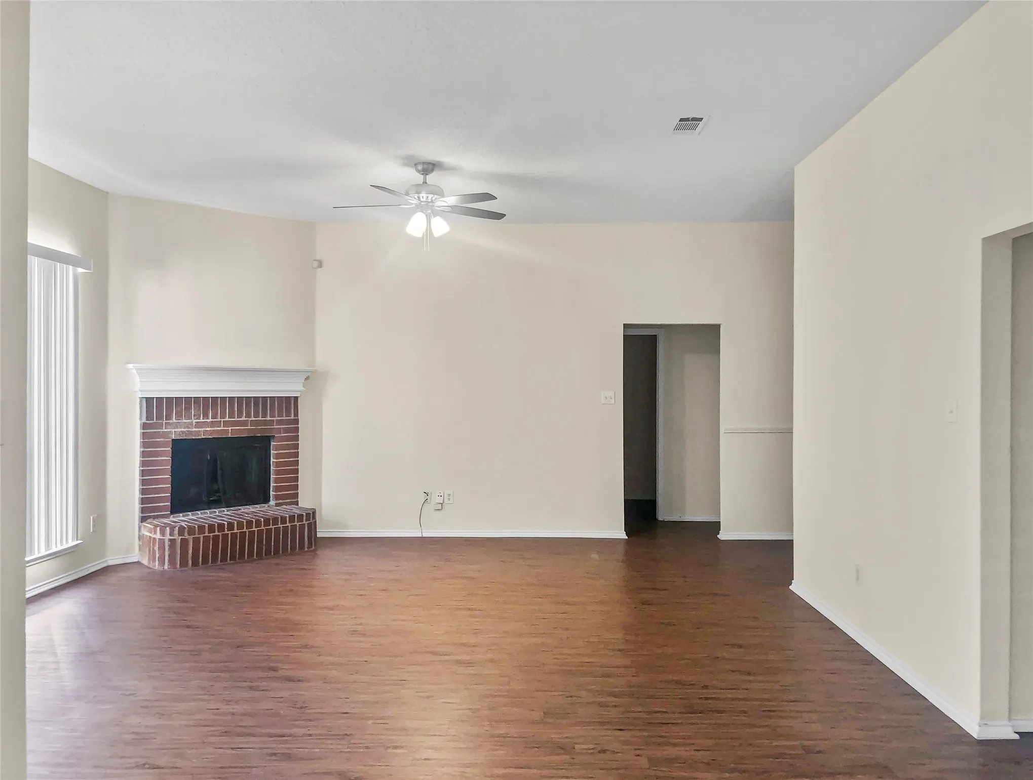 Living Room has a ceiling fan light fixture & decorative fireplace!