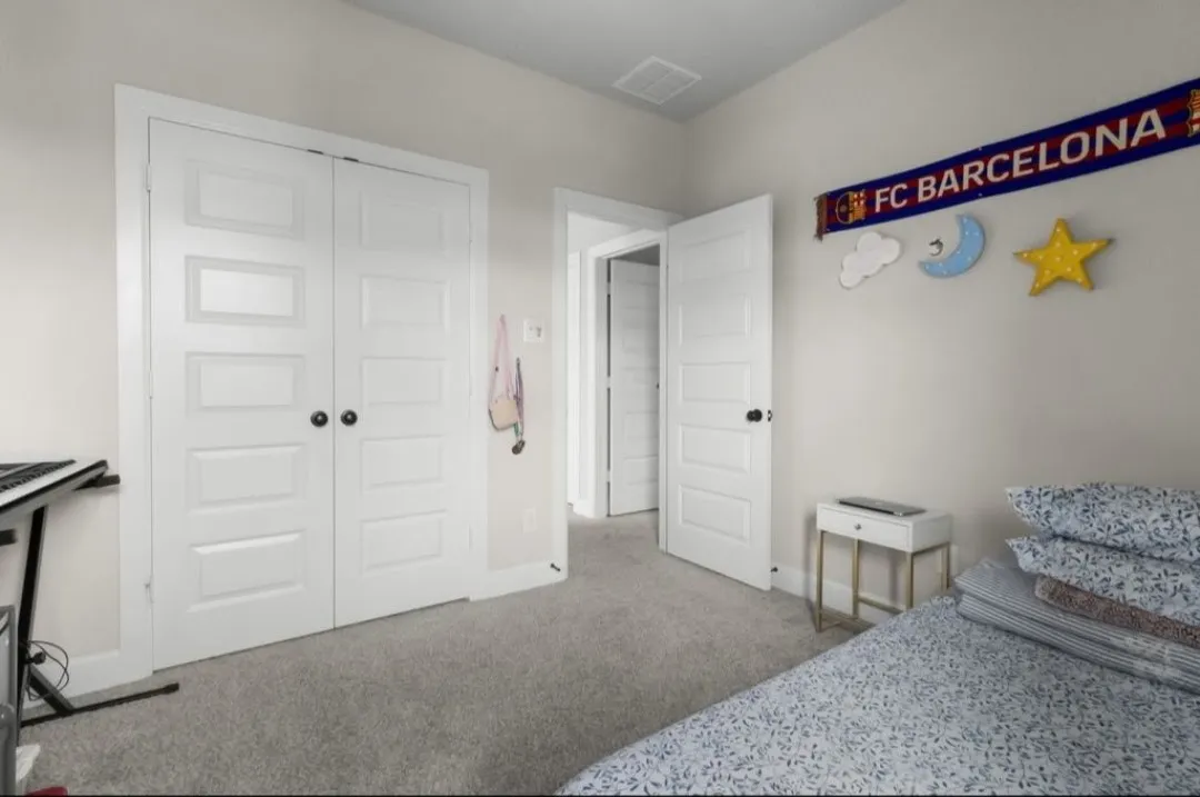 Plush gray carpeting throughout, white paneled doors, and light neutral wall paint