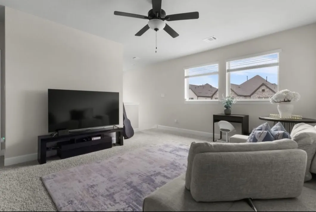 White cabinetry with dark hardware, stainless steel appliances, speckled stone countertops, gray subway tile backsplash, and wood-finish flooring