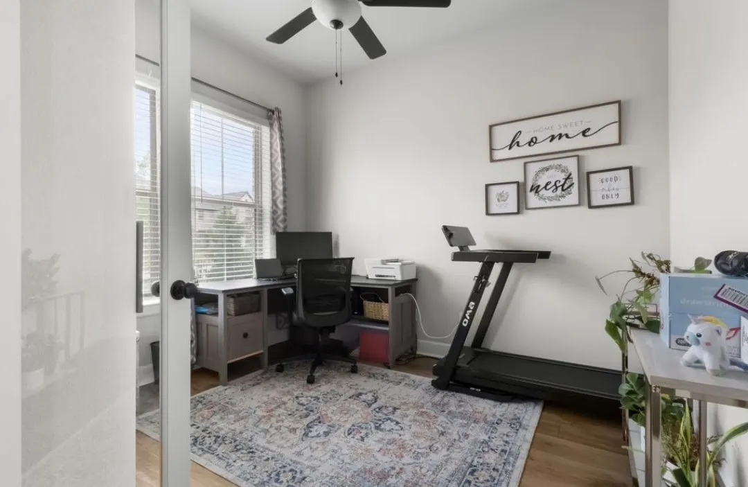 Hardwood-finish flooring, ceiling fan, and window with blinds