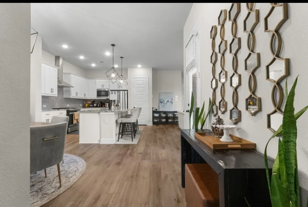 Open-concept living space with wood-finish flooring