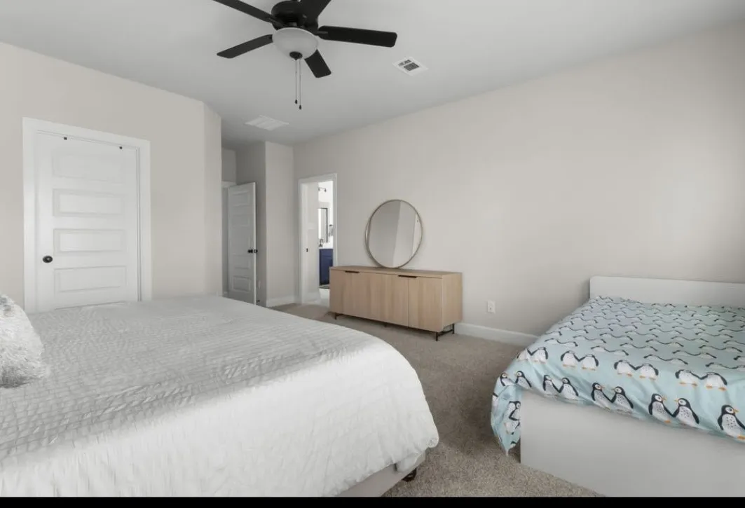 Neutral wall paint, ceiling fan with integrated lighting, paneled interior doors, and carpet flooring