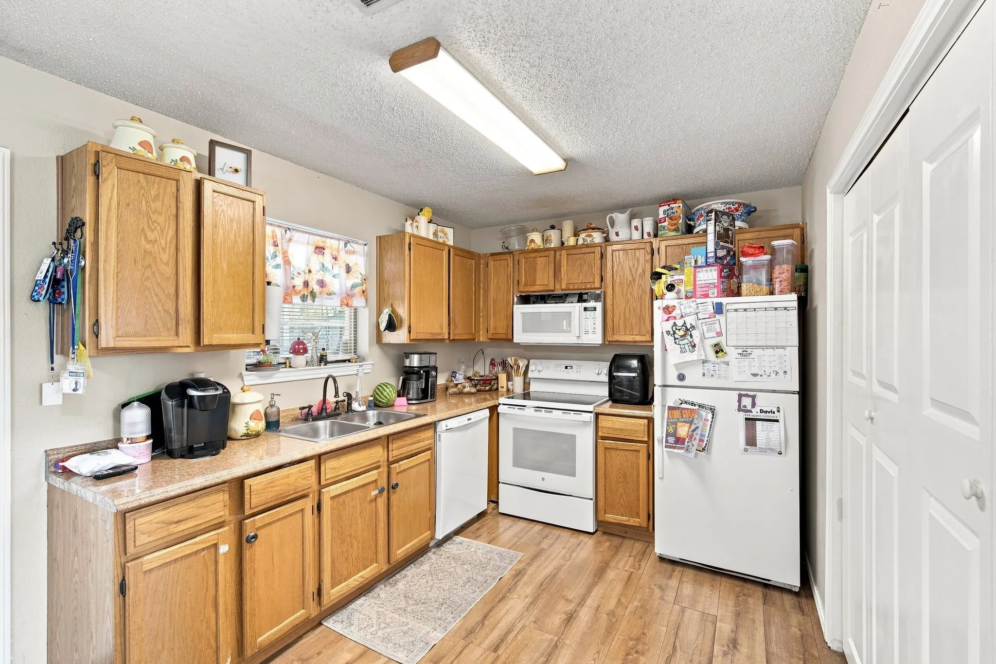 Open kitchen with washer and dryer utility access