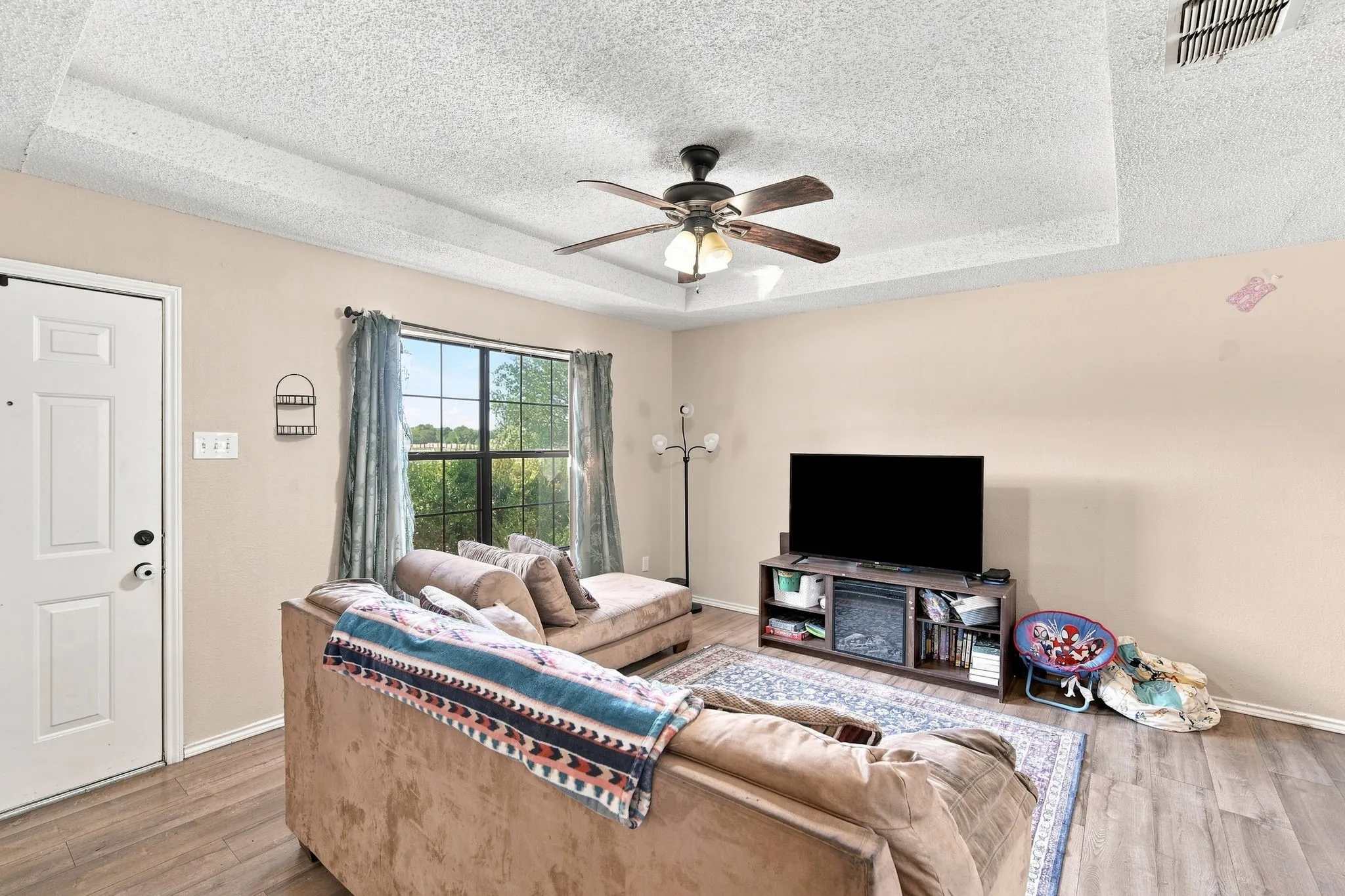 Natural light and ceiling fan in living room