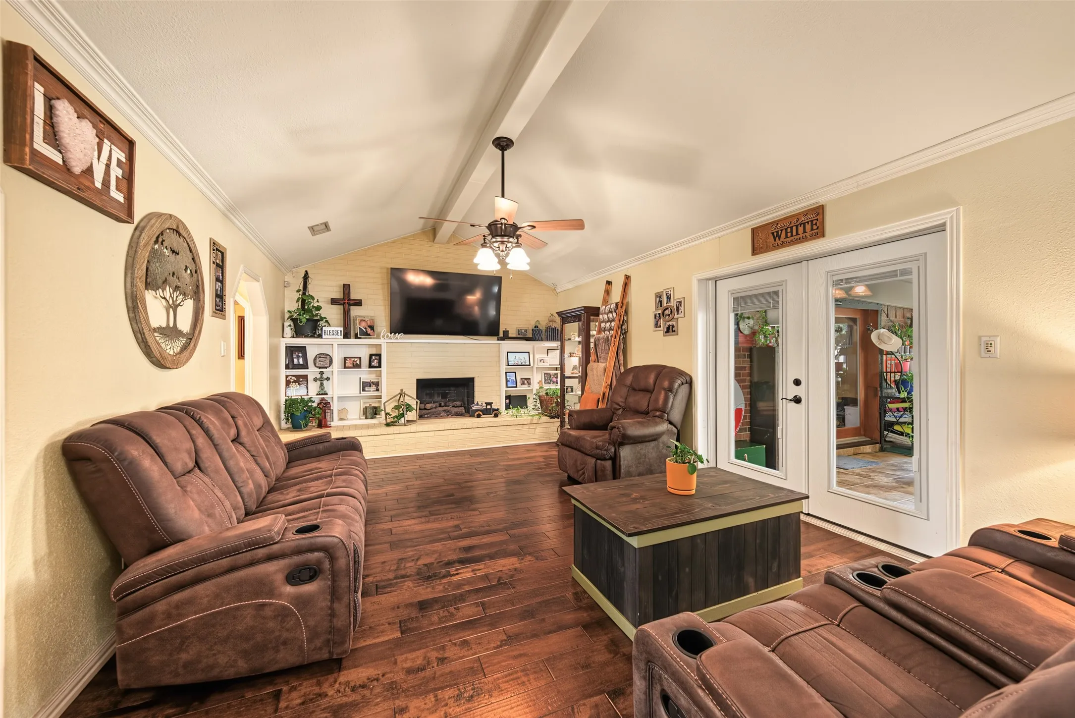 Another view of living room featuring glass doors opening to sun room