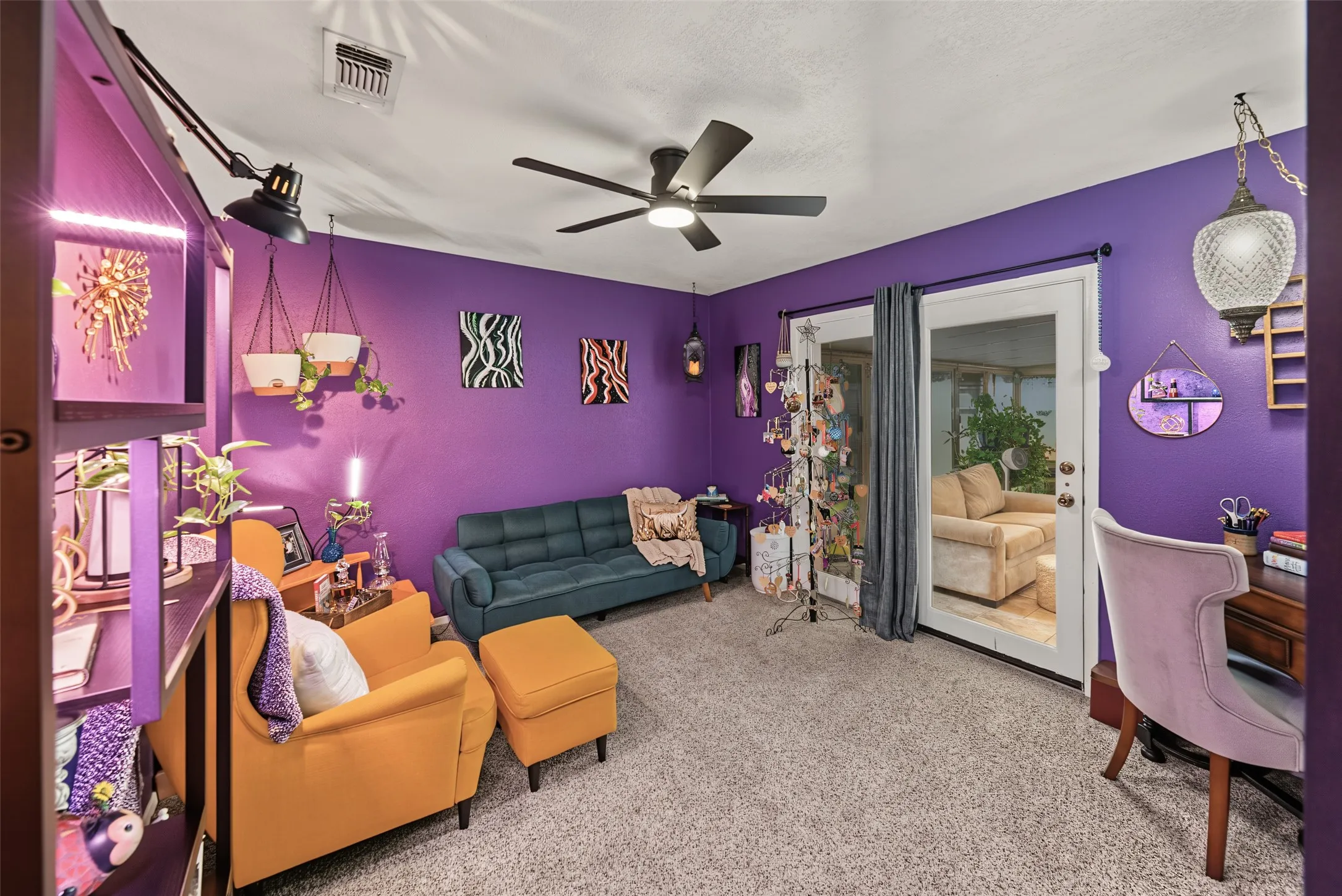 4th bedroom currently being used as a zen relaxation lounge. Great for entertaining, guest suite or home office. French glass doors open to sunroom. Plush carpet and ceiling fan with walk in closet for ample storage