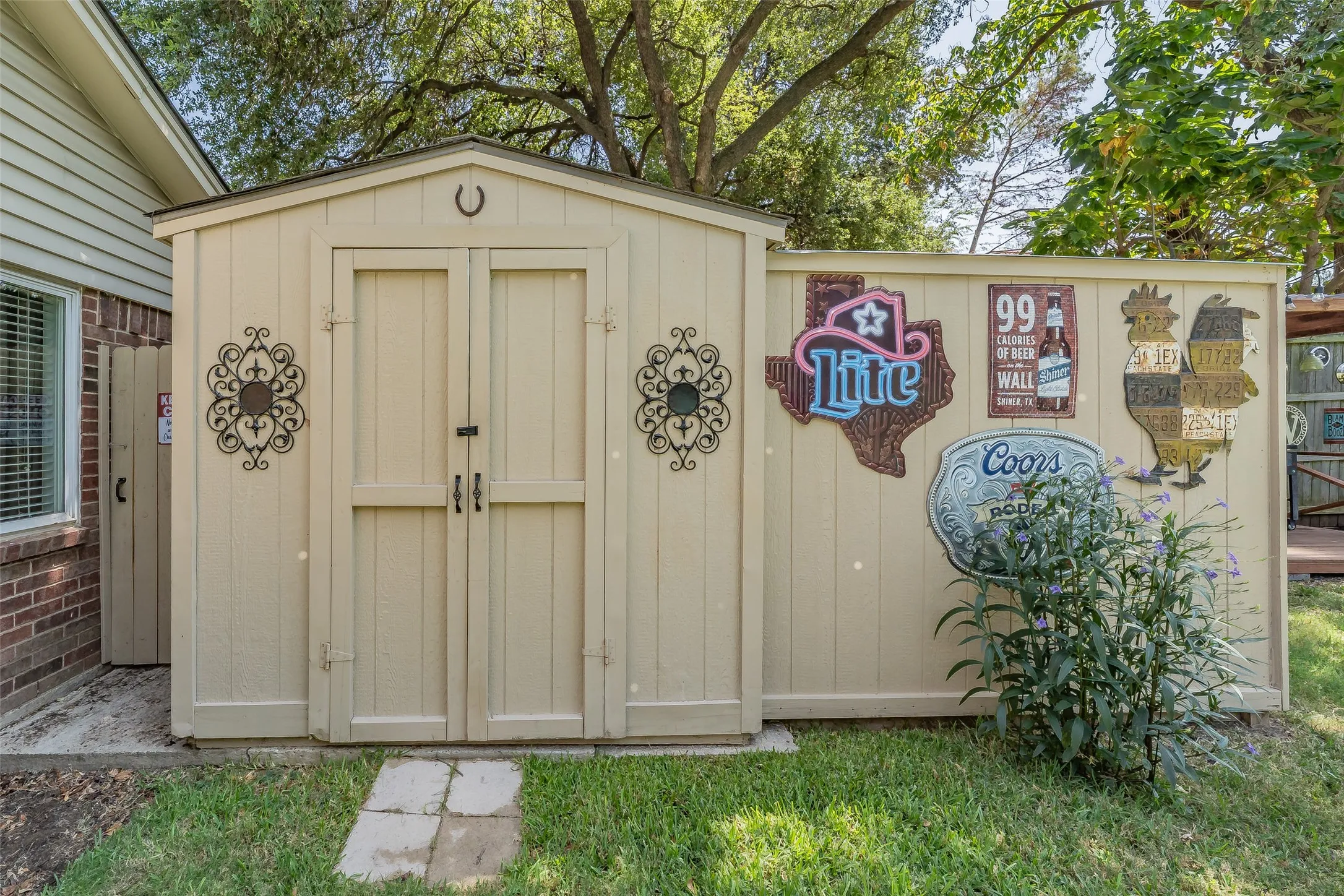 Outdoor storage shed with double doors, wood panel siding