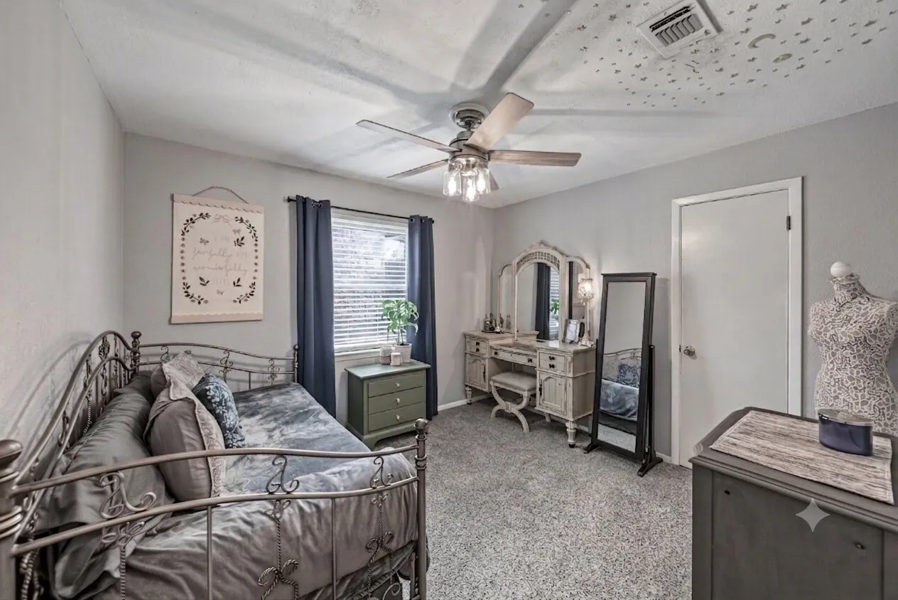 Ceiling fan with light fixture, plush carpet and walk in closet