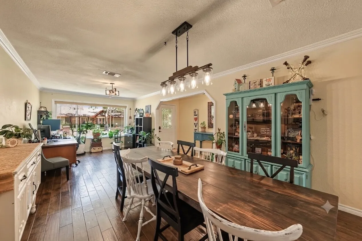 Spacious dining room featuring natural wood floors throughout, beautiful large window overlooking space for sitting area or flex space.