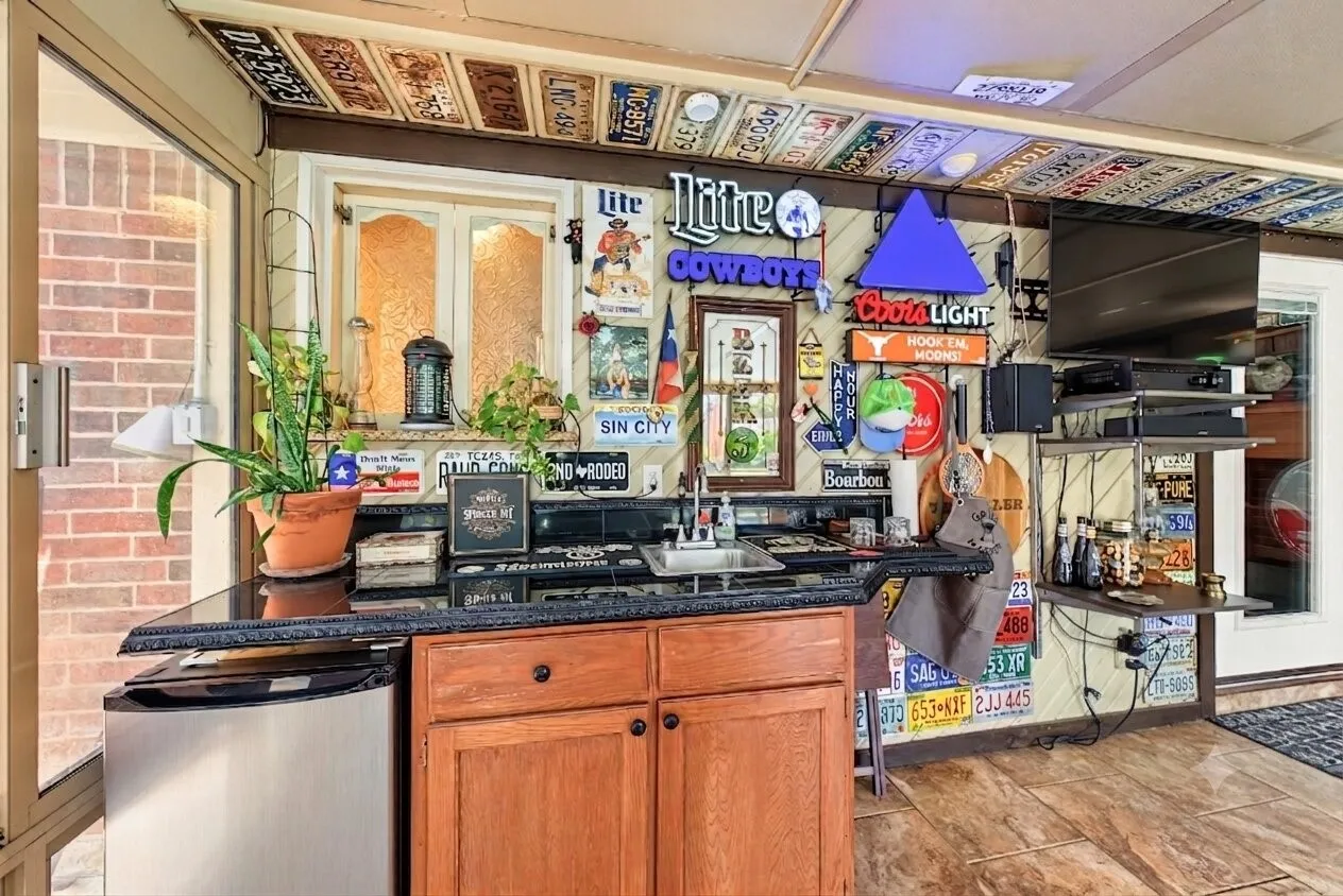 Another view of sun room, featuring built in wet bar for entertaining with window access to serve from kitchen area