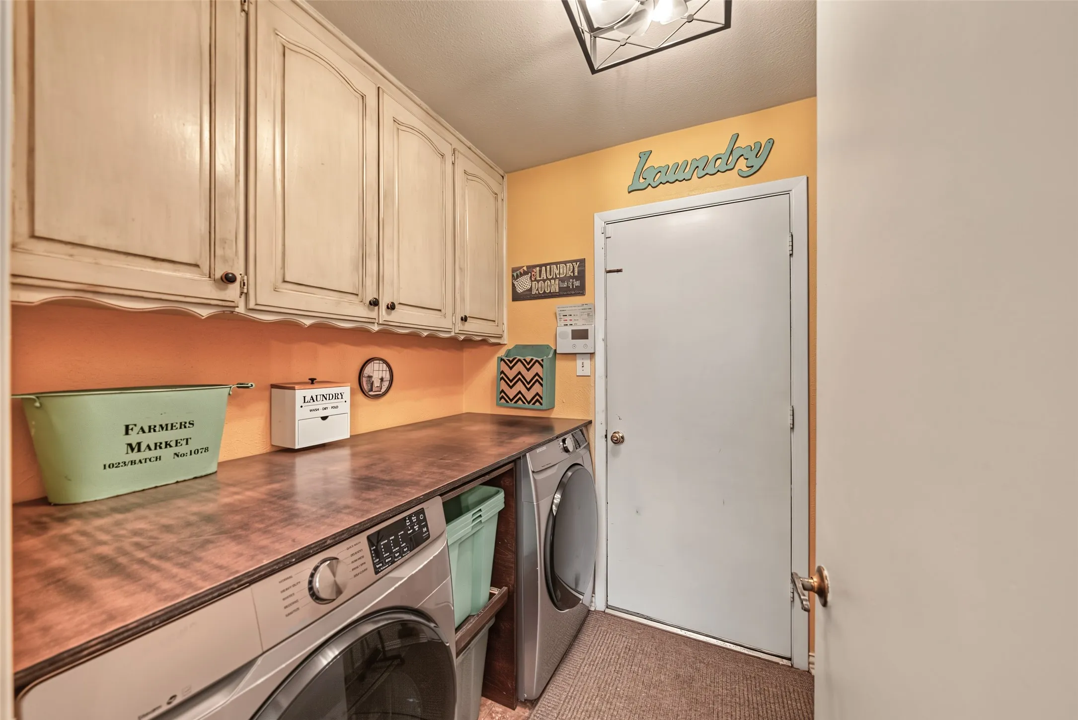 Custom cabinetry and durable countertop surface in laundry room