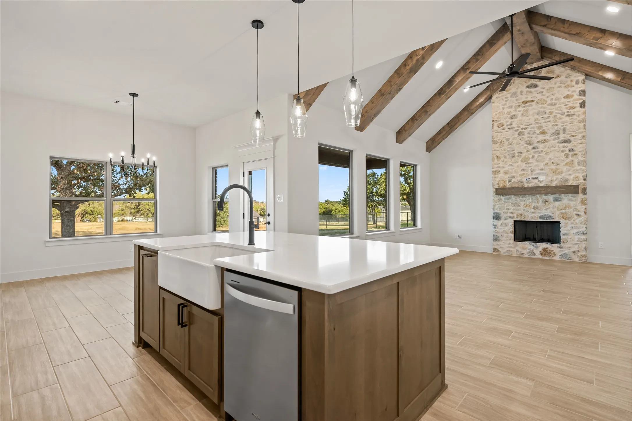 Central island with a farmhouse sink and integrated dishwasher