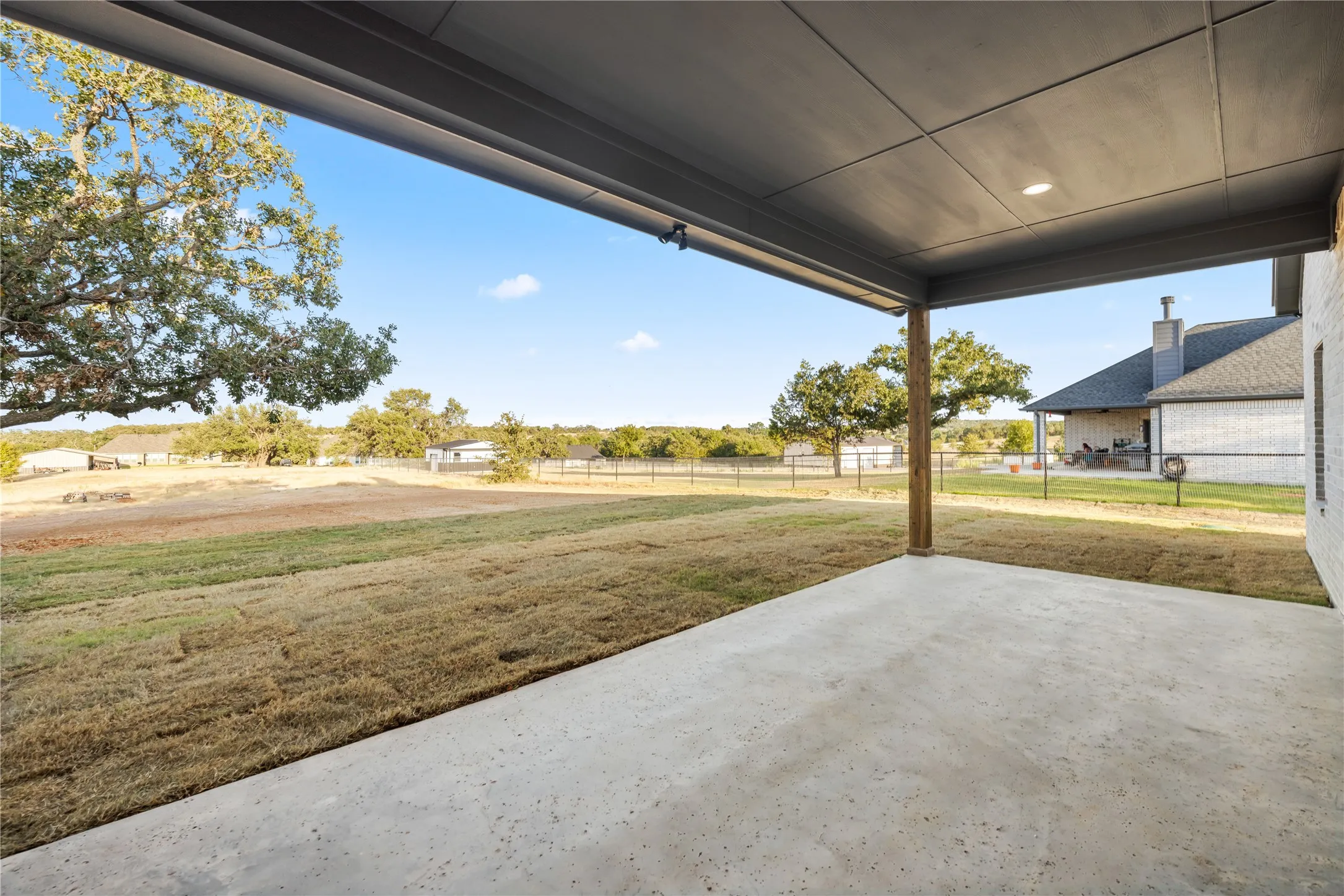 Covered patio with recessed lighting, concrete flooring, and a wood support column