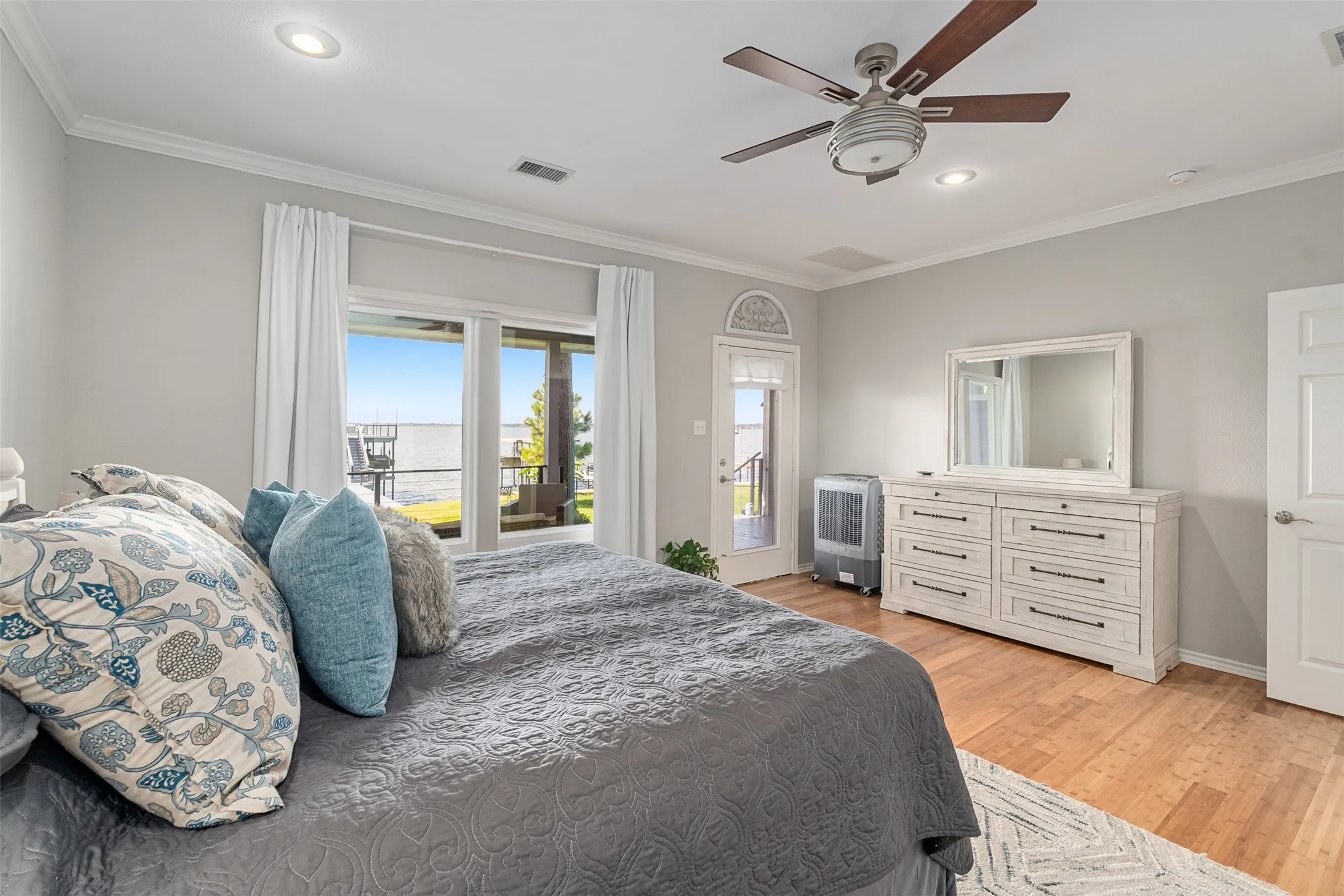 bamboo flooring, recessed lighting, ceiling fan, crown molding, and glass panel door