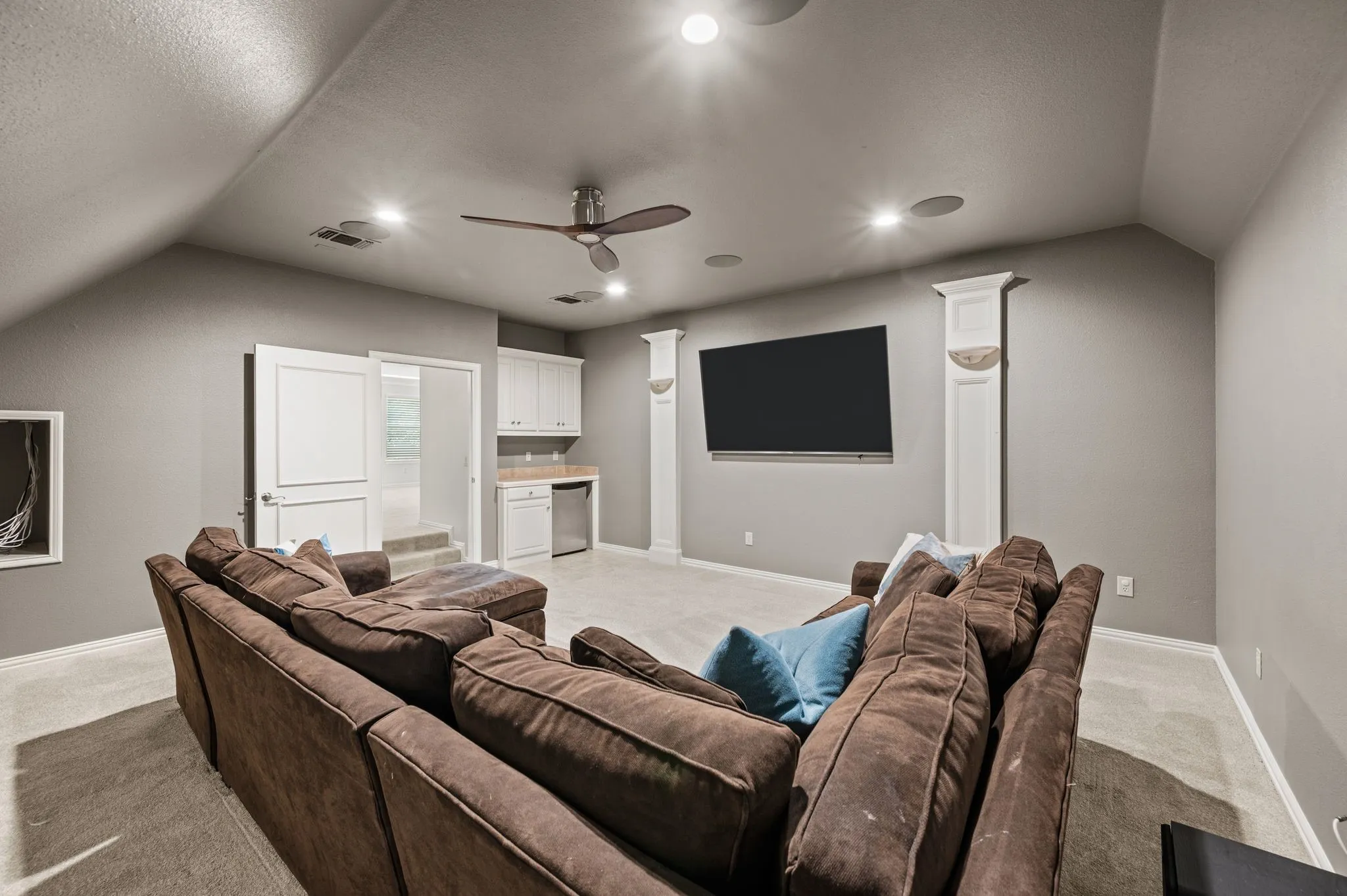 upstairs media room with built in cabinets