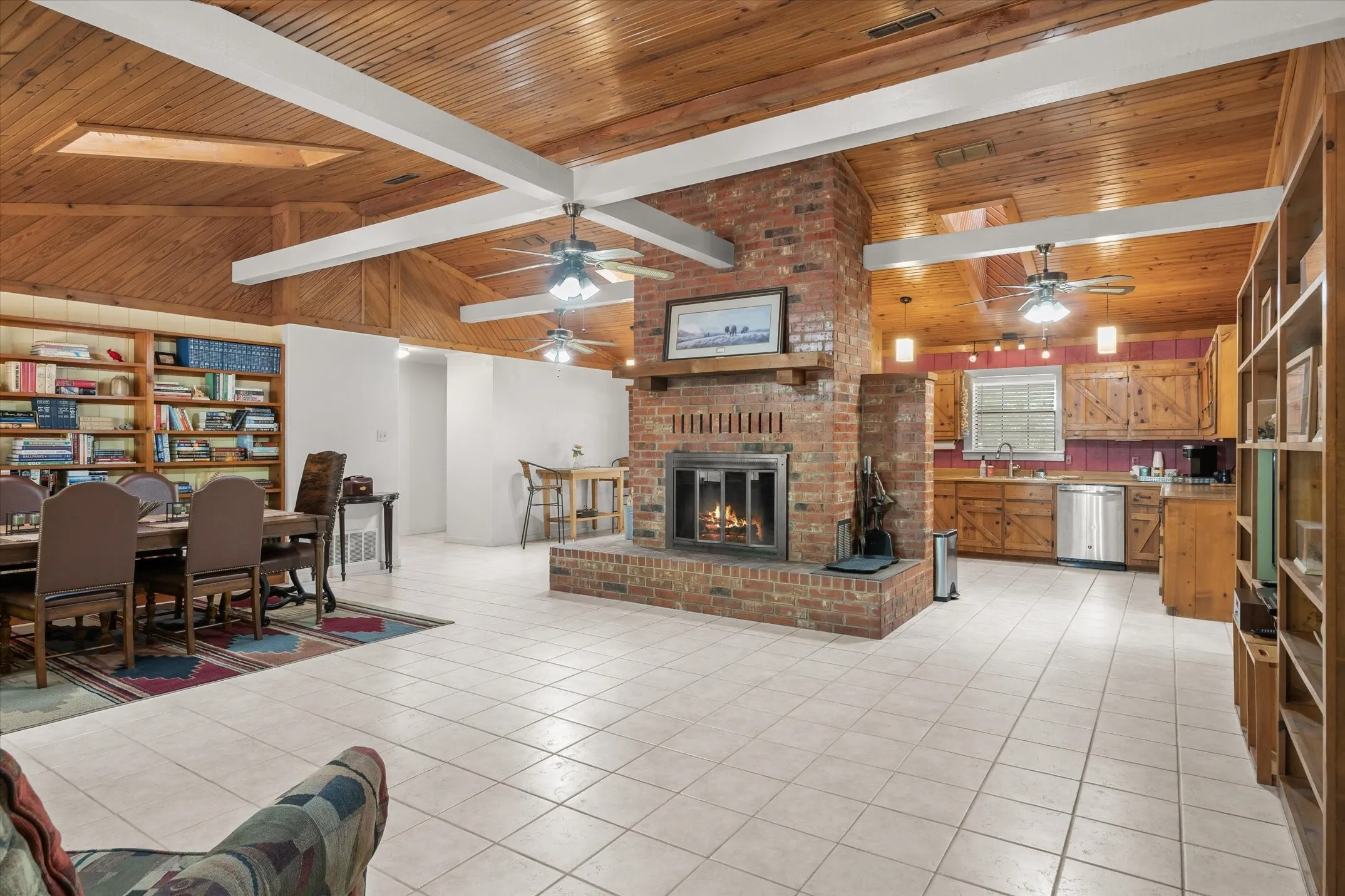 Large wood burning brick fireplace has a blower that will heat the home